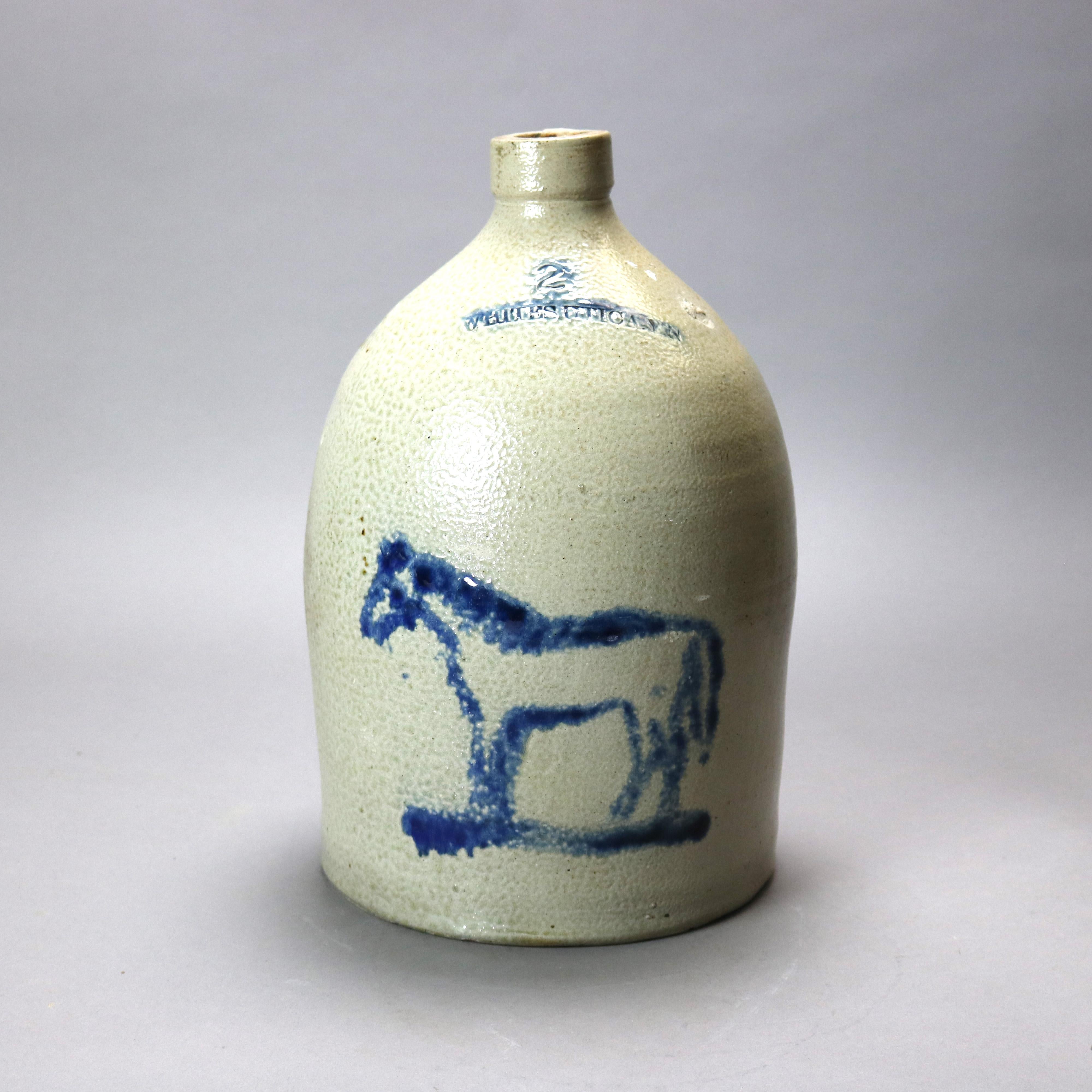 A rare antique two gallon stoneware jug by Whites of Utica, New York offers salt glazed stoneware construction cobalt blue decorated with horse, crock maker embossed with transposed NY as photographed, 19th century

Measures - 14''h x 9''w x 9''d.