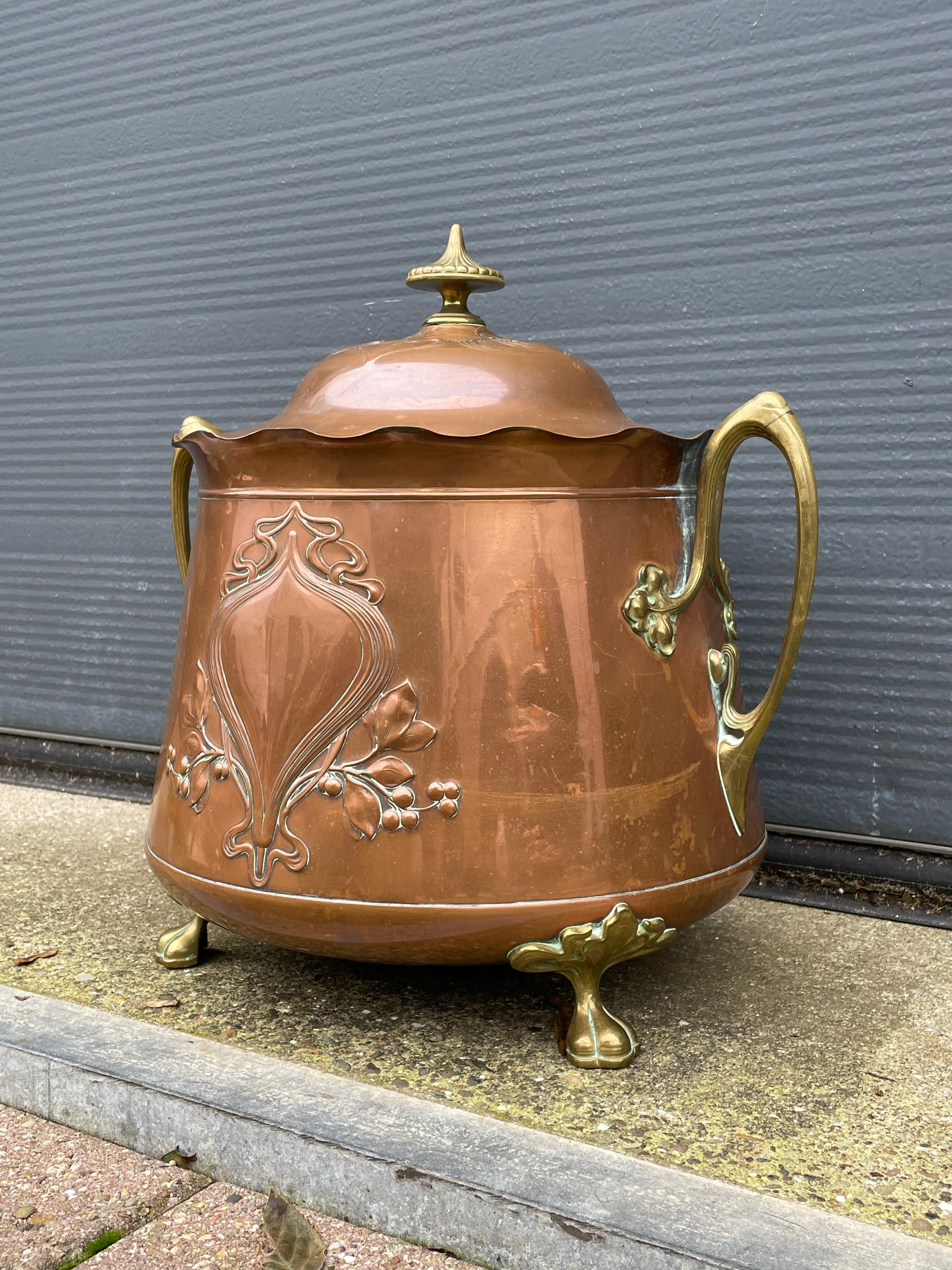 Large, decorative and top quality workmanship brass, copper and bronze bucket.

This one is for the connoisseurs, because it ticks all the Arts and Crafts boxes. The first owner who would have had this piece custom made or who bought it from one of