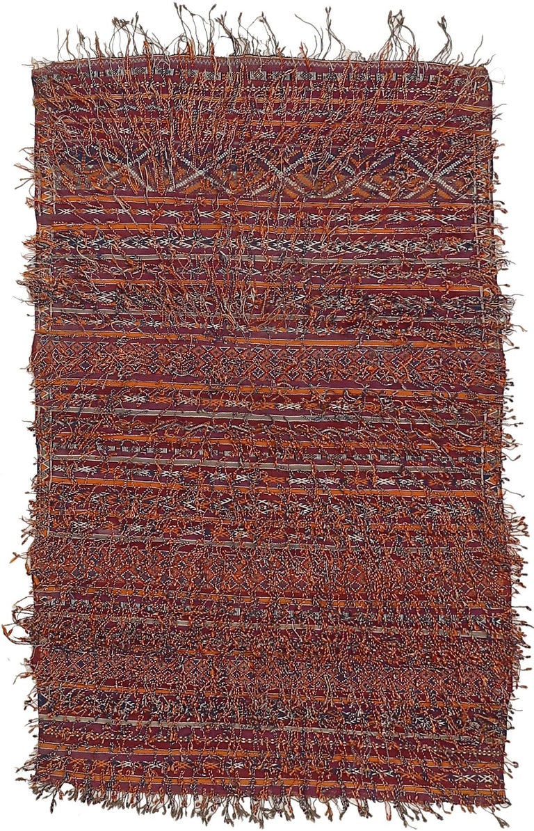 A rare mixed technique Berber rug ascribed to the Zemmour people, located in the Moroccan Middle Atlas, originally used as a saddle cover - an item of great prestige among Berber tribes. The pattern consists of horizontal compartments containing