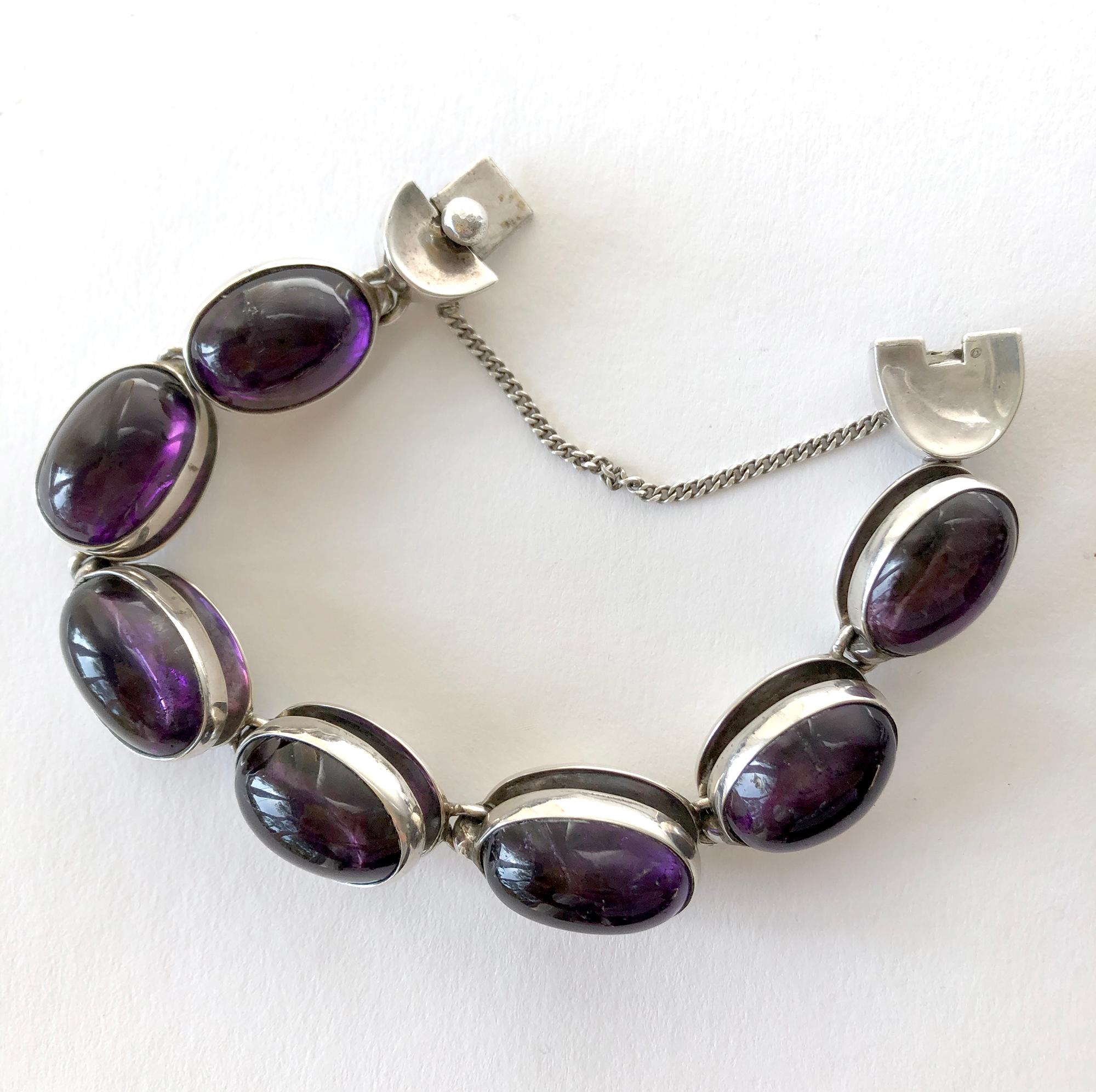 Rare to find jewelry suite of amethyst cabochons within sterling silver link necklace, bracelet and earrings all created by Antonio Pineda of Taxco, Mexico circa 1950's.  Necklace measures 17