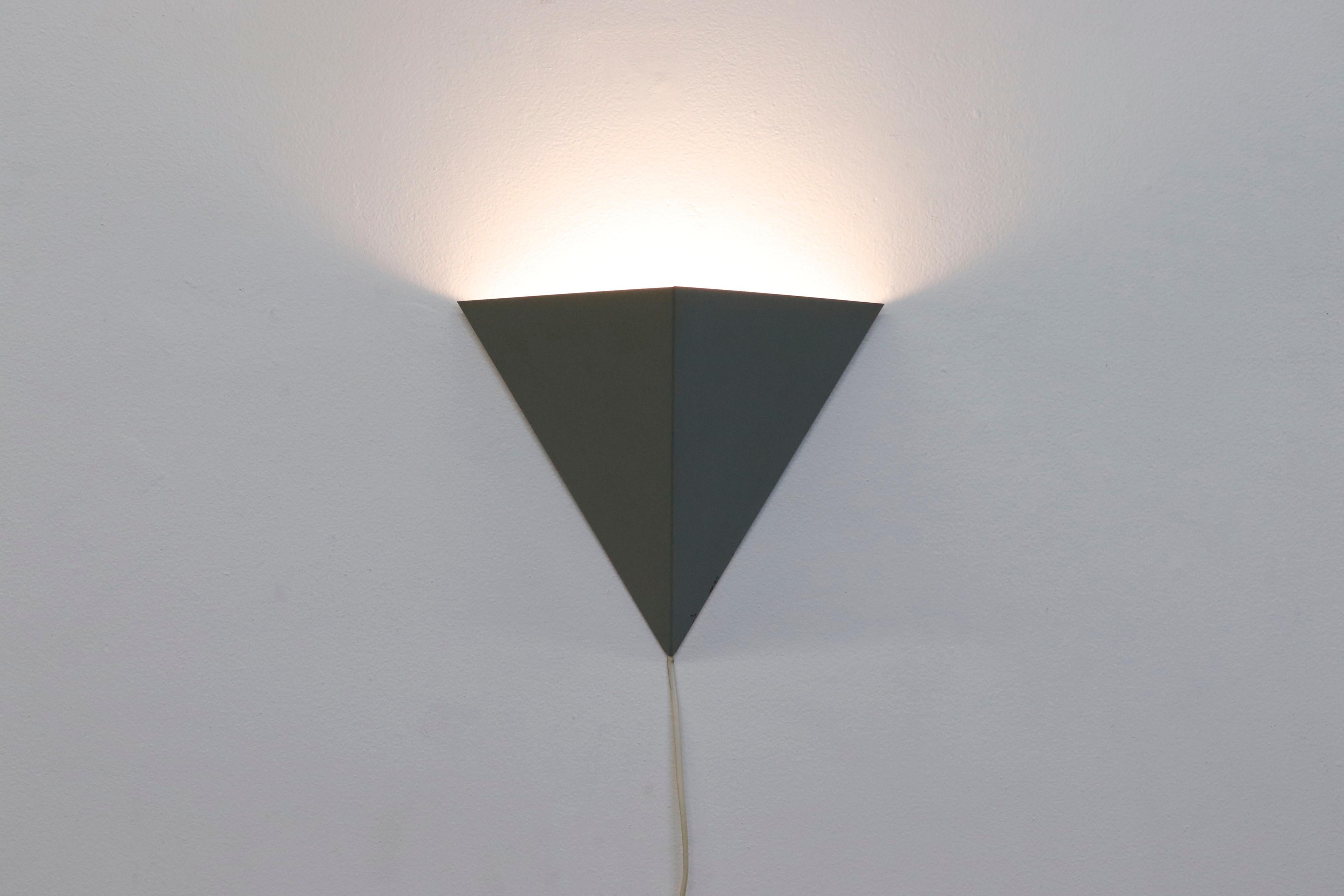 Rare Anvia triangular wall sconce with sleek gray enameled aluminum shade in original condition with wear and scratching consistent with age and use.