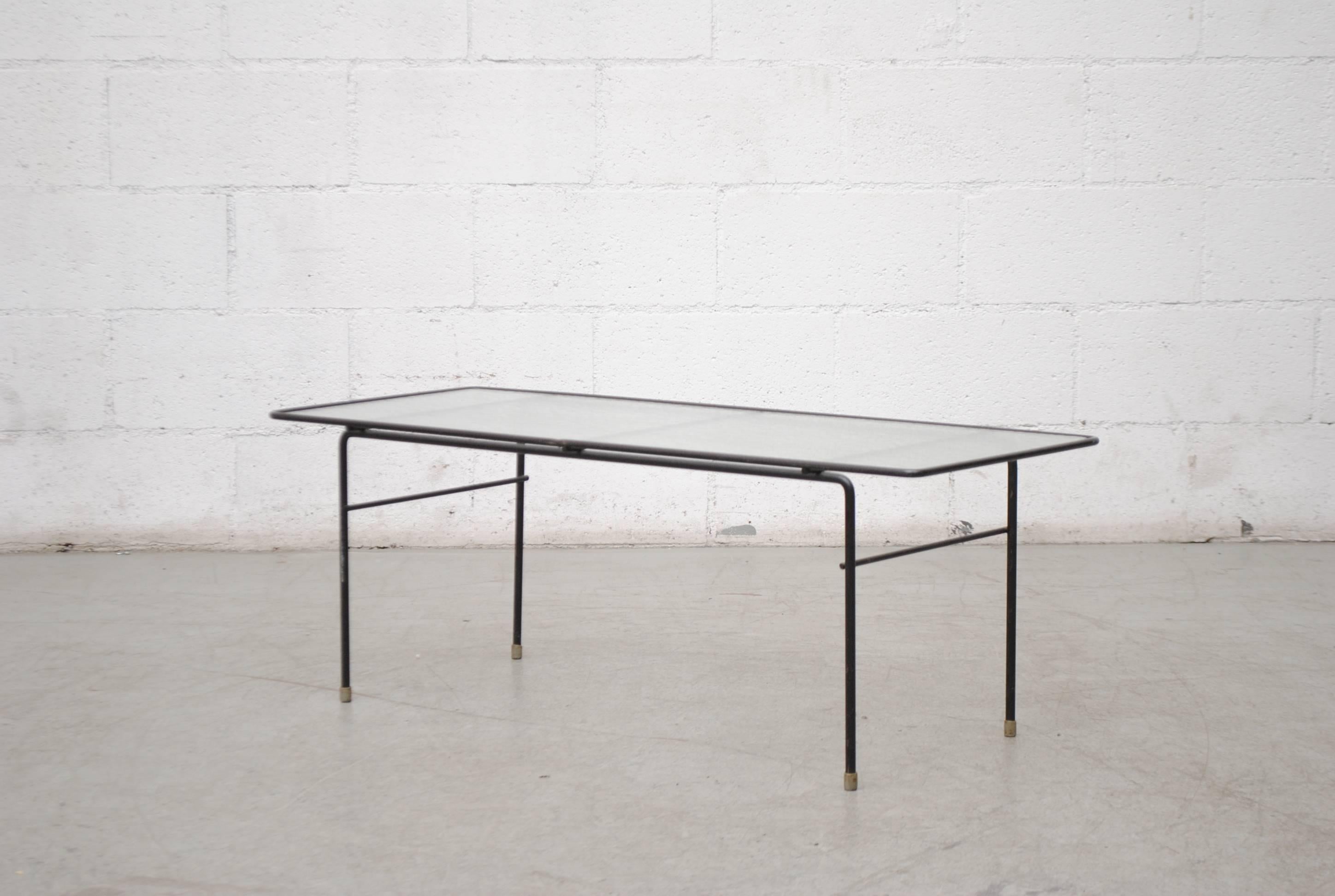 Rare Gispen black enameled metal wired frame coffee table with privacy glass top designed by AR Cordemeyer in original condition with visible wear consistent with its age and usage.