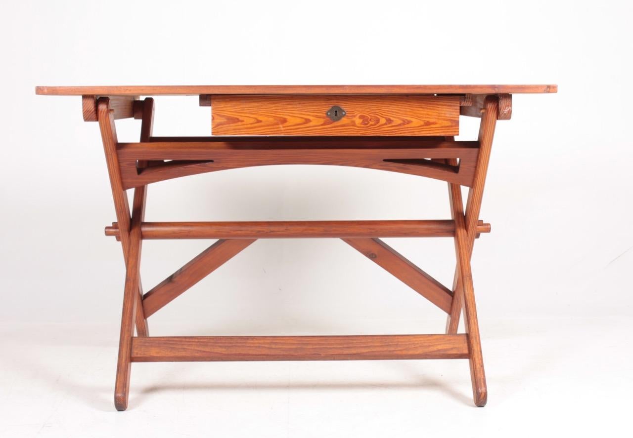 Adjustable height, working table in patinated solid pine. Designed by MAA. Martin Nyrop as interior for Copenhagen town hall in 1905. Made in Denmark by Rud Rasmussen cabinetmakers. Great original condition.

  