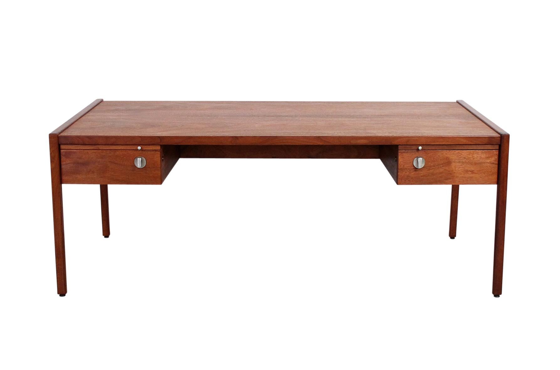 Rare architect or partners desk by American designer Jens Risom. This piece features sculptural hardware, pull out work surfaces front and back, and what appears to be 