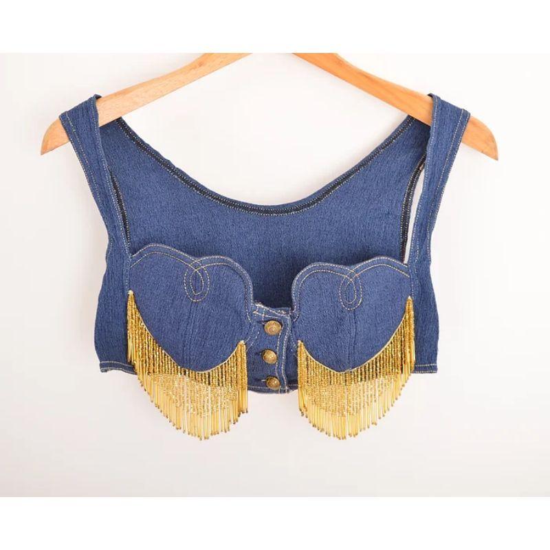 Rare, Decadent 1990's Archival Moschino Jeans label stretchy moc denim bralet. 
This superb, Archival piece features heart shaped cups, contrast stitching, buttons down the front and intricate gold beaded fringing. 

MADE IN