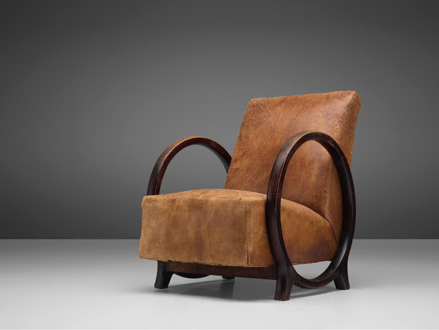 Jacques Adnet for Compagnie des Arts Français, armchair, leather and darkened beech, France, circa 1930.

Stunning lounge chair designed by Jacques Adnet in circa 1930. A rare model in leather and darkened beechwood. The design features an unusual,