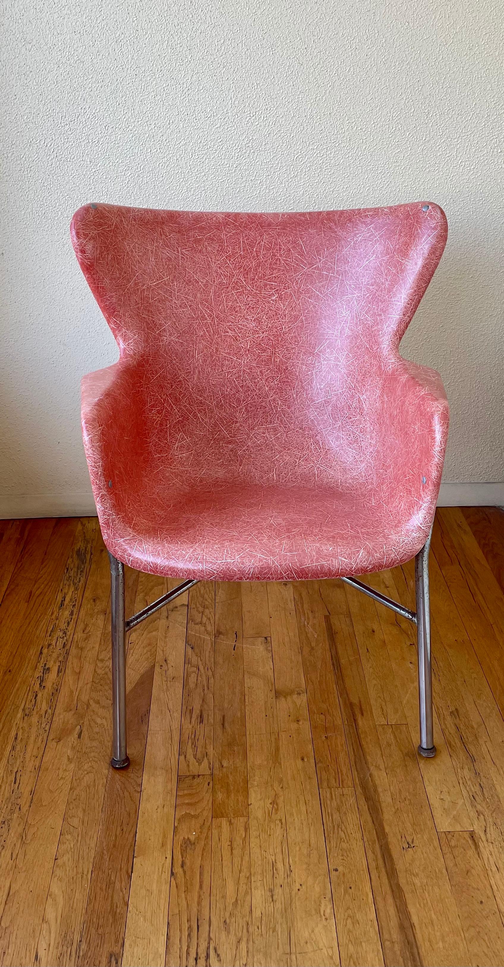 A rare example of a fiberglass armchair with a chrome base similar to the Eames design this chair its more wide and bigger, the chrome shows some pitting as shown the shell its nice in color and condition.