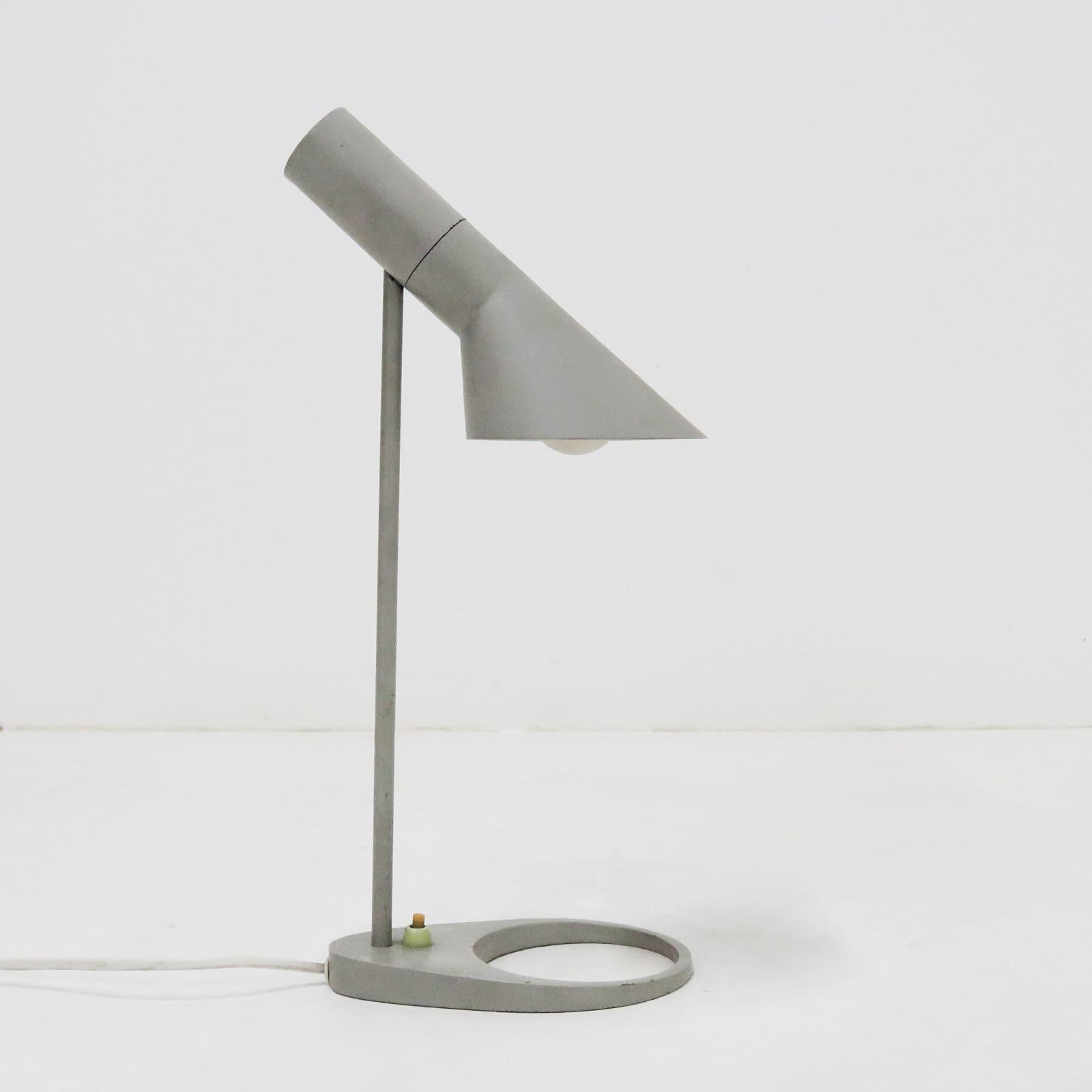 Classical grey desk lamp in steel with original lacquering designed by Arne Jacobsen, probably Axel Annell on license by Louis Poulsen, Denmark, angle of shade can be adjusted to optimize light distribution, wired for US standards, one E27 socket,