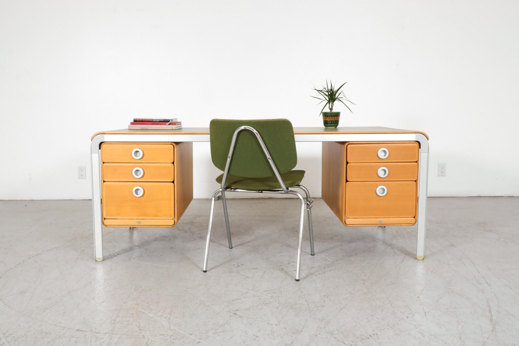 Writing desk designed by Arne Jacobsen in 1971. Part of the 'DJOB' system for Denmark's National Bank. The desk has stacking drawers on both sides and is made of beech wood with an anodized aluminium frame and a green laminate top. In original