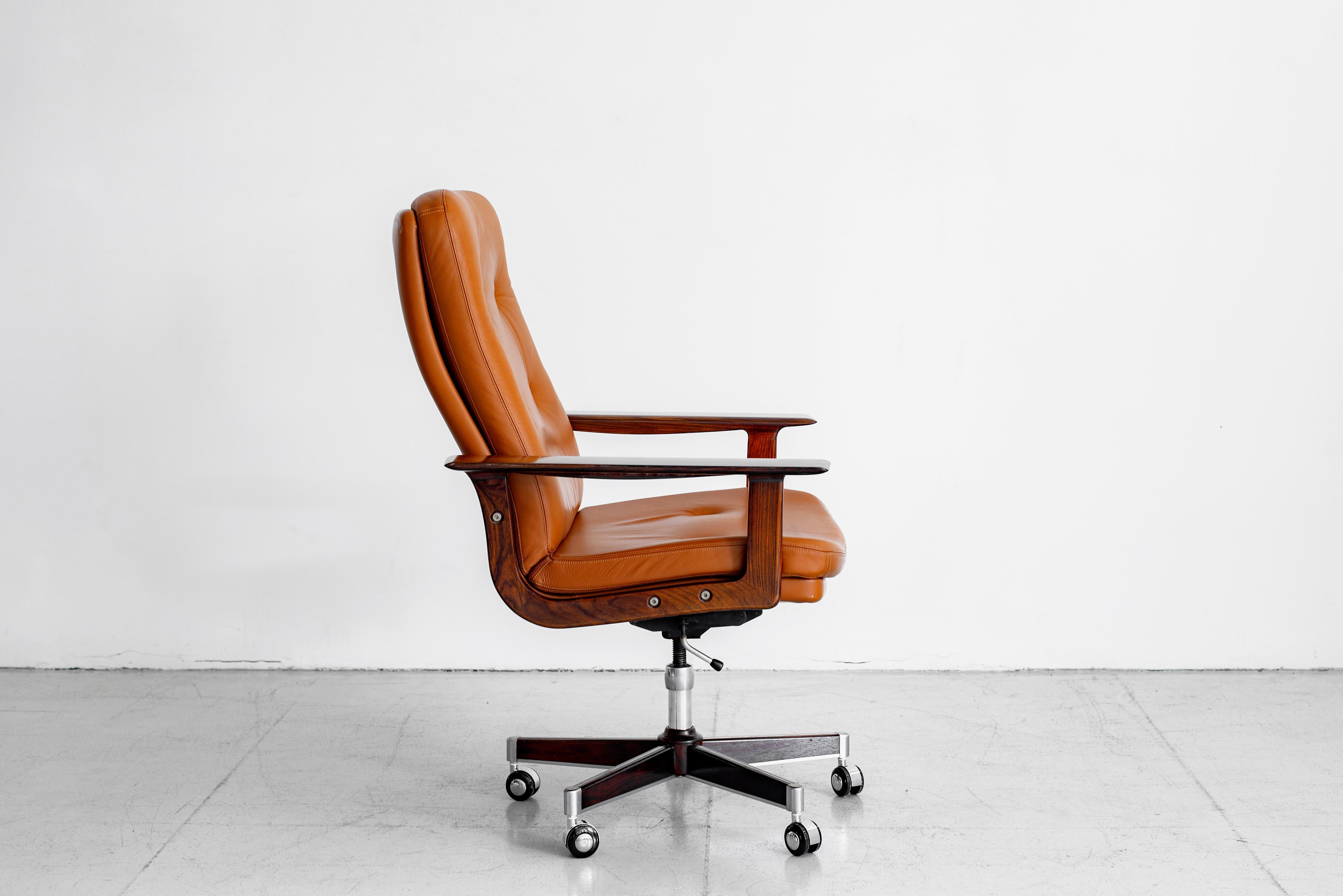 Rare Rosewood and original caramel leather executive office chair by Arne Vodder. 
Original rosewood base and arms.
Chair swivels and pivots. 
Adjustable in height. 
Leather has wear typical with its age - see detailed photos.