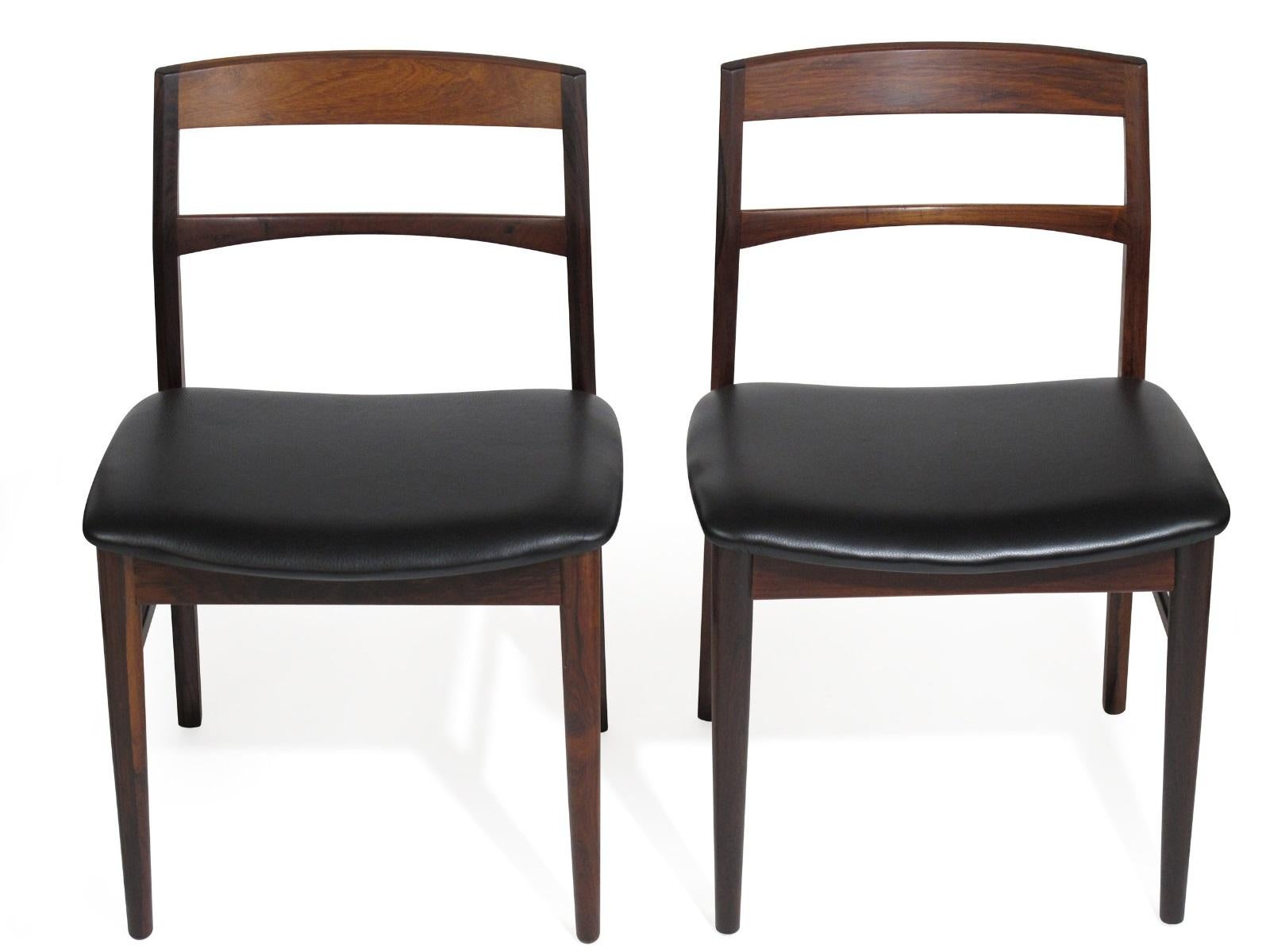 Rare eight Brazilian rosewood dining chairs designed by Arne Vodder. Features solid rosewood frame with comfortable angled back rests. Highest quality construction with newly upholstered in black leather. Excellent condition.