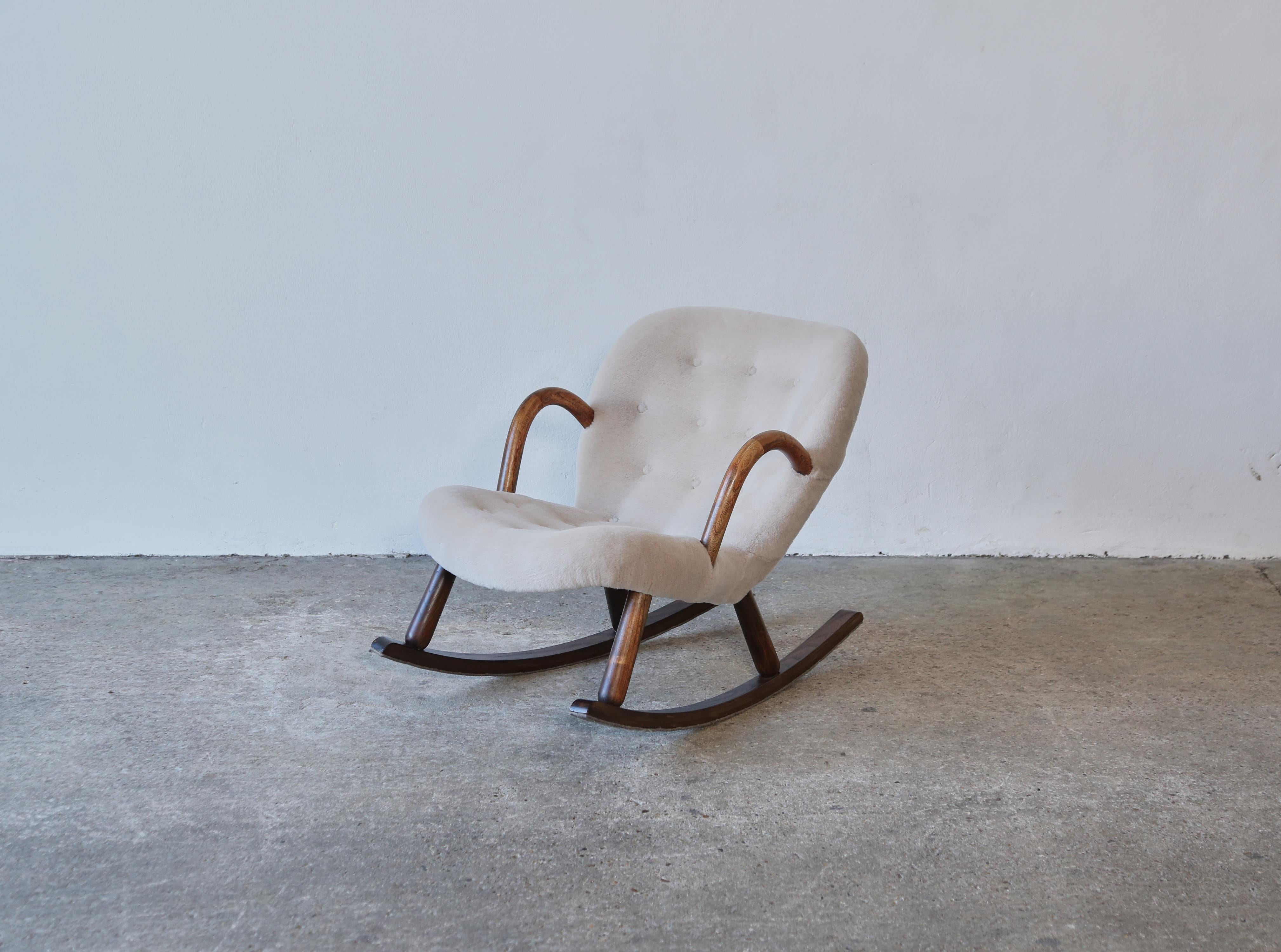 A rare Clam Rocking Chair by Arnold Madsen and produced in Denmark or Norway in the 1950s.  Newly upholstered in a premium, pure alpaca wool fabric. Fast shipping worldwide.   
  
