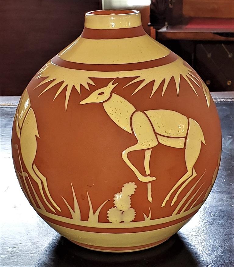 Presenting a beautiful and rare Art Deco ceramic vase by Leon Delfant for Boch Freres Keramis (BFK).

This is a gorgeous piece of Art Deco ceramic by the renowned maker BFK.

It features a series of prancing deer with flowers and grasses and