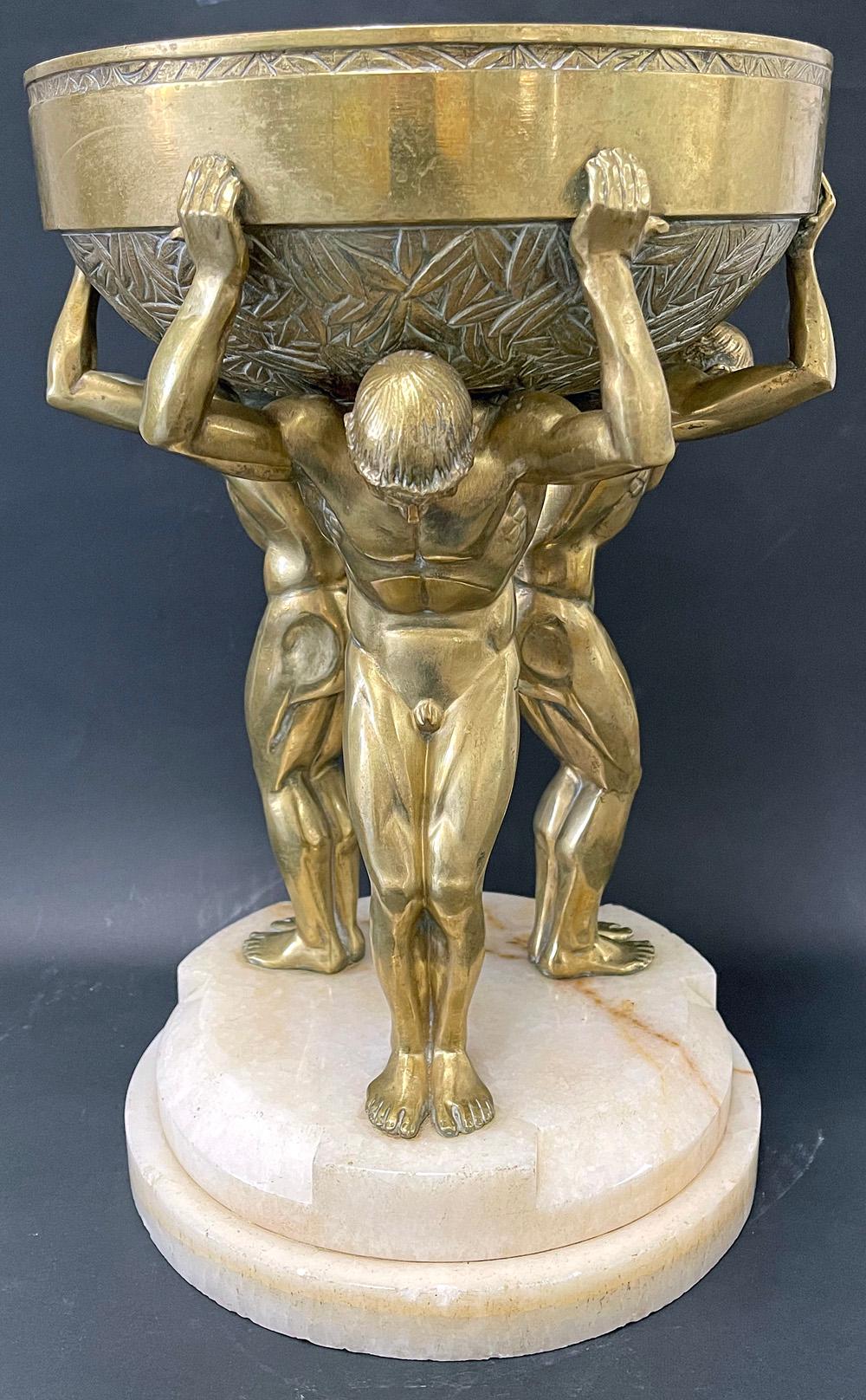 One of the rarest and most spectacular of all the high style Art Deco sculptures made in 1920s France, this gilded centerpiece bowl supported by three nude male figures was created by Maurice Guiraud-Rivière. Originally produced in two or three