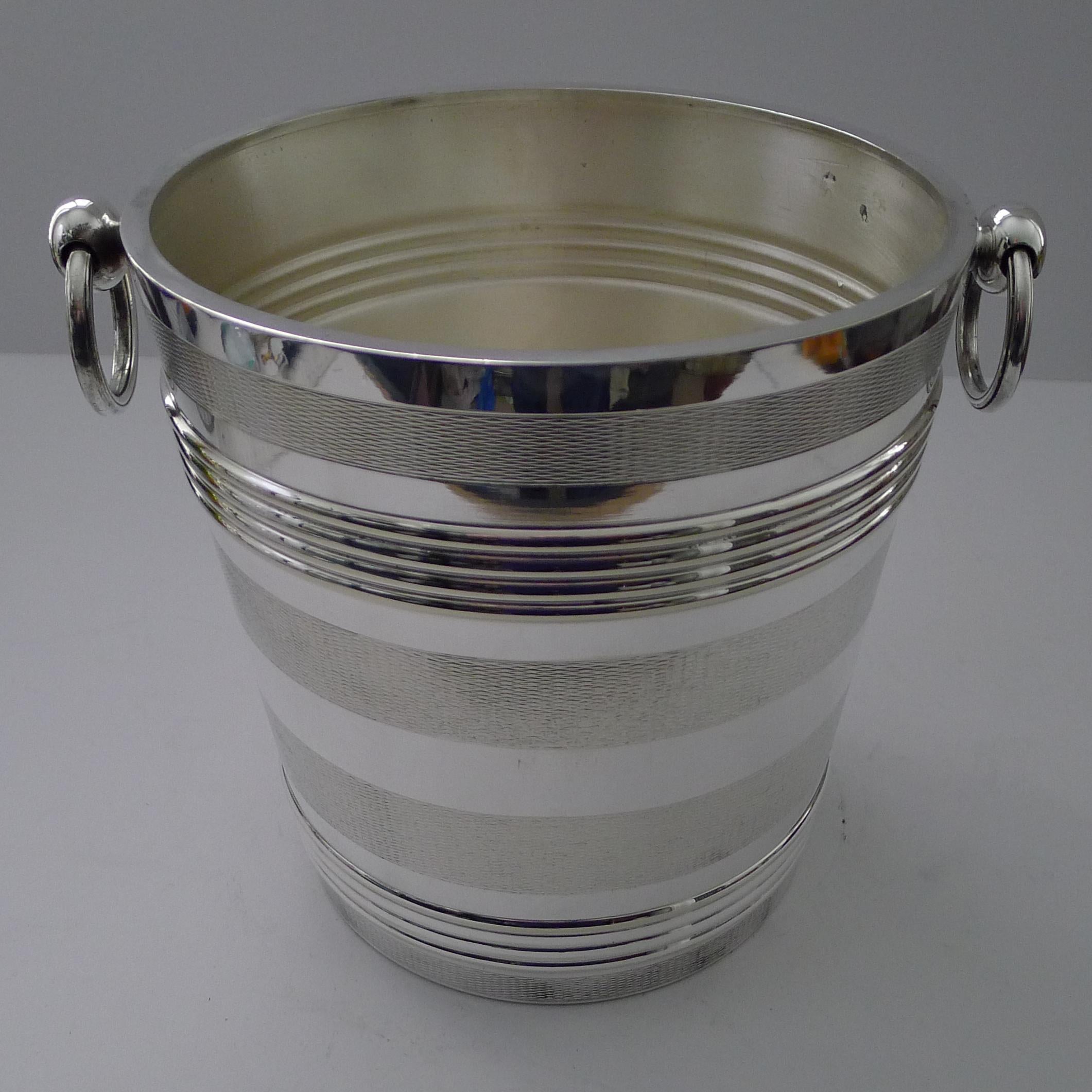 A rare example from the creme de la creme of French silversmith's, Orfèvrerie Christofle of Paris.

This grand silver plated Champagne bucket or wine cooler is beautifully decorated with engine turned bands running around the sides, typically Art