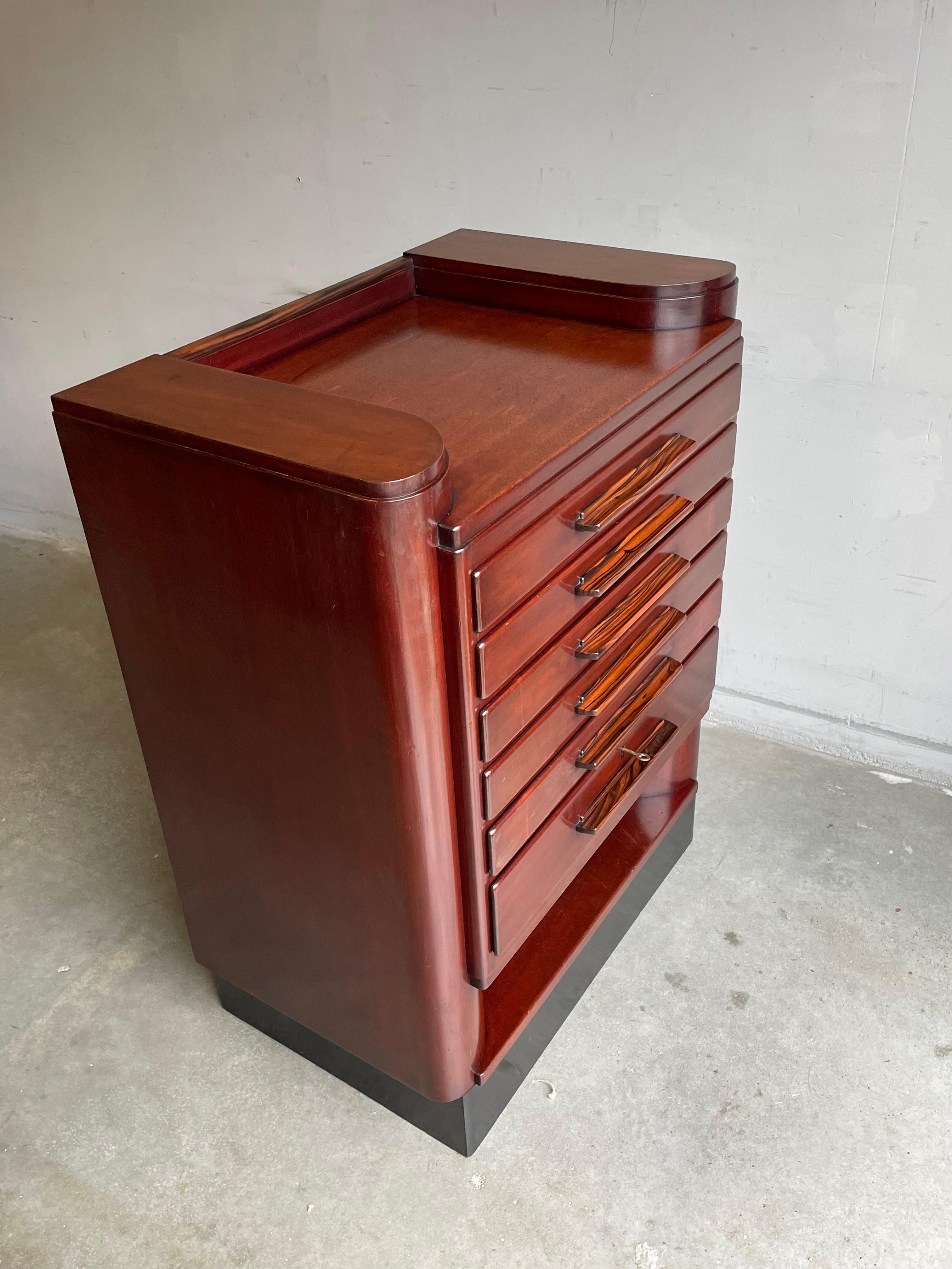 Beautifully designed AND executed, Dutch Art Deco chest with stunning drawers and handles.

Having been antique furniture sellers for the first half of our antique selling careers, we immediately recognized this rare and striking chest of drawers.