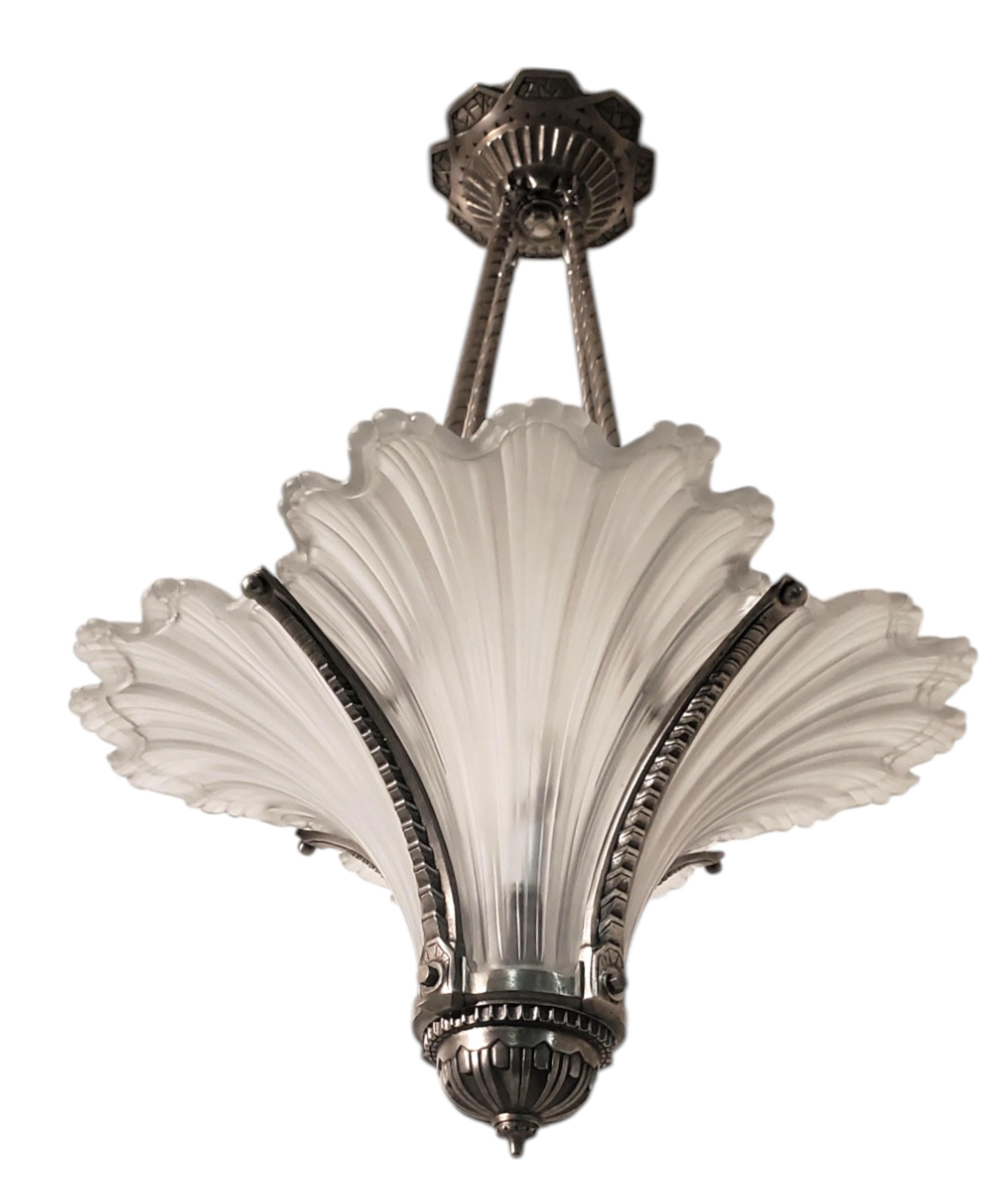 This exquisite and unusual Original French Art Deco chandelier embodies the elegance and craftsmanship of the 1930s.  Attributed to EJG .
 Jean Gauthier 
The design features frosted art glass shades shaped like cresting waves, reminiscent of