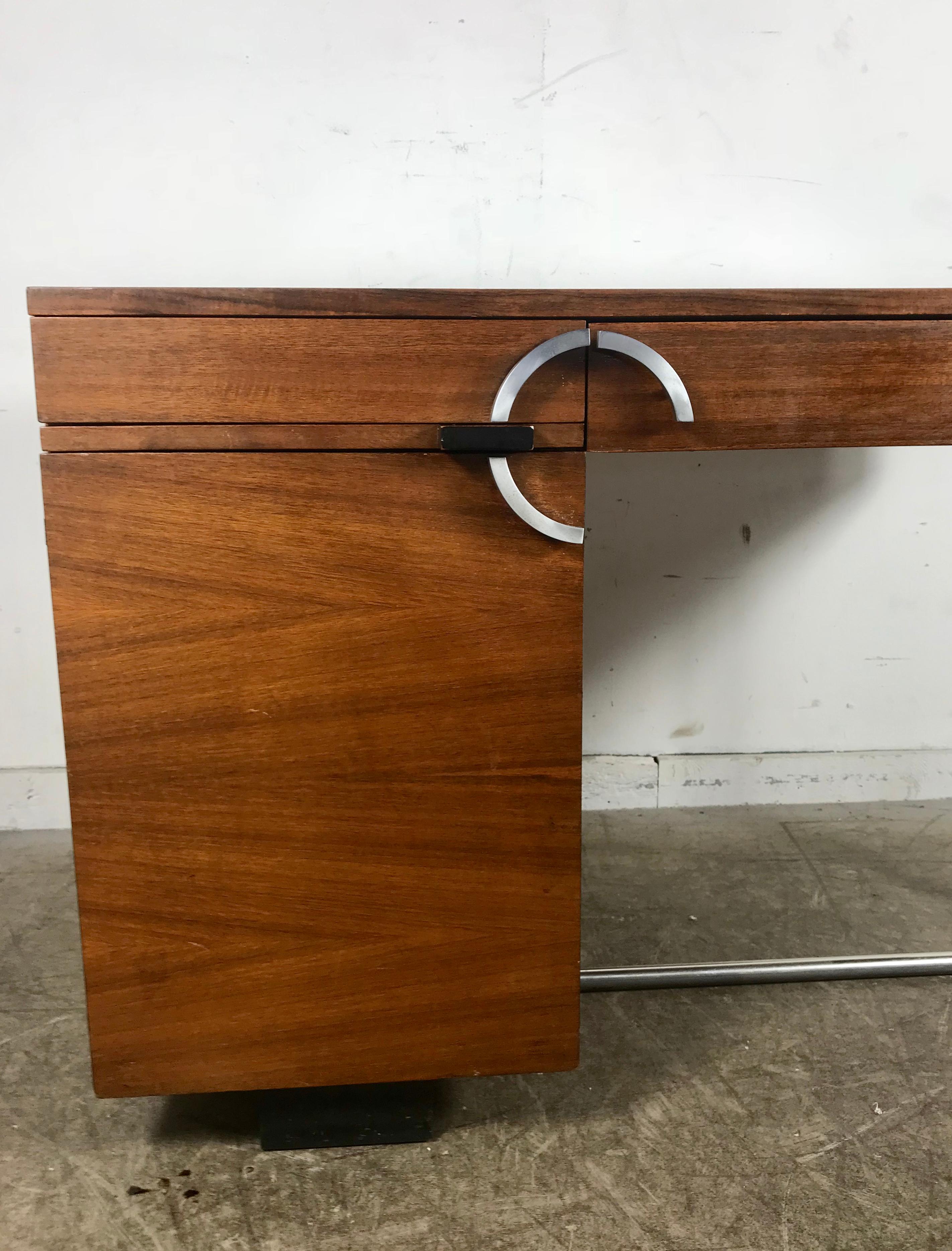 Rare Art Deco Gilbert Rohde for Herman Miller East Indian Laurel desk, circa 1937. Amazing quality and design, featuring East Indian Laurel wood retaining its original pencil drawer, pull-out writing shelf, file drawer and stunning nickel hardware
