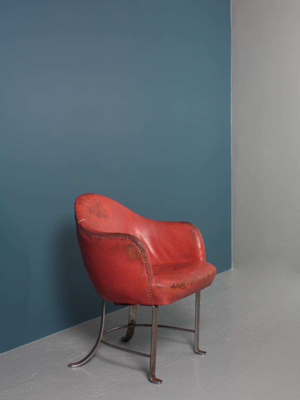 Lounge chair with frame of nickel-plated flat steel, upholstered with original patinated red leather. This chair is designed for Lolland Falsters Industri & Landbrugsbank in 1935.
