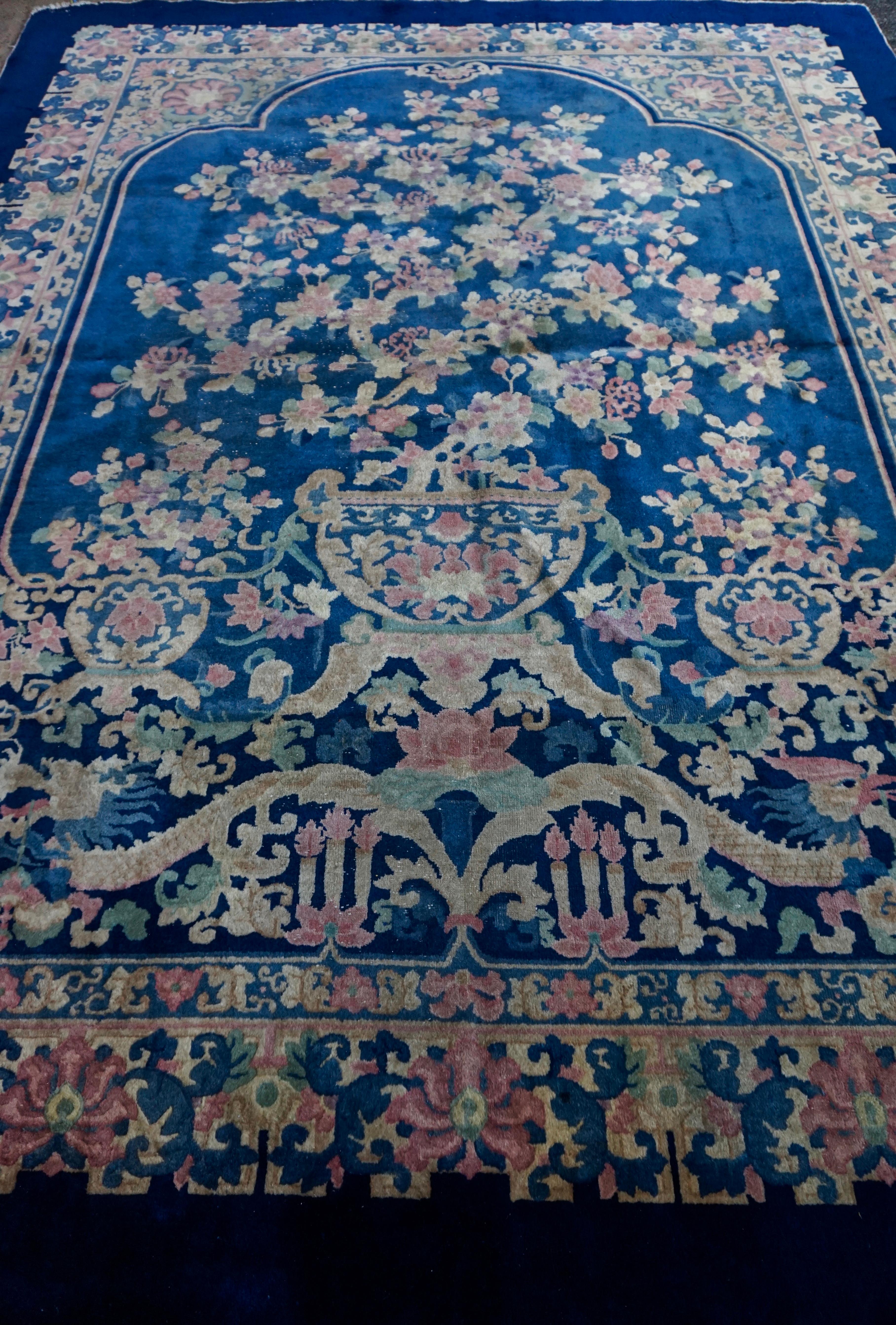 Rare Nichols rug with an unusual dragon and phoenix theme likely custom made. Blossoming honeysuckle plant flanked by smaller plants and perched above a dragon and phoenix (Yin & Yang or Success & Prosperity). The scene of bliss is framed within an