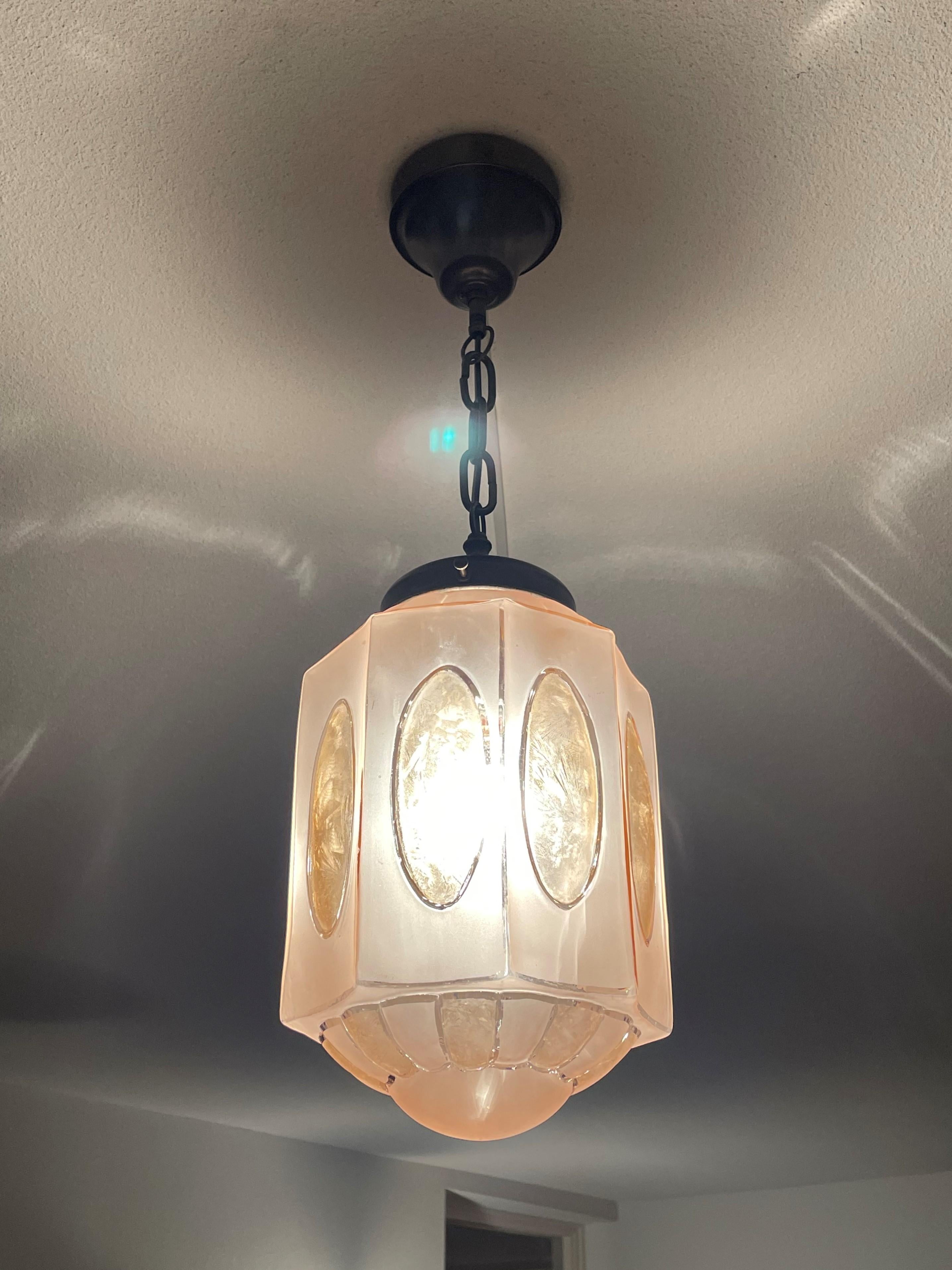 Rare and beautiful Art Glass pendant from the heydays of the European Art Deco era.

In our view this rare Art Deco pendant with its wonderful color and geometrically rounded design could be the perfect light fixture for an entrance, a landing or