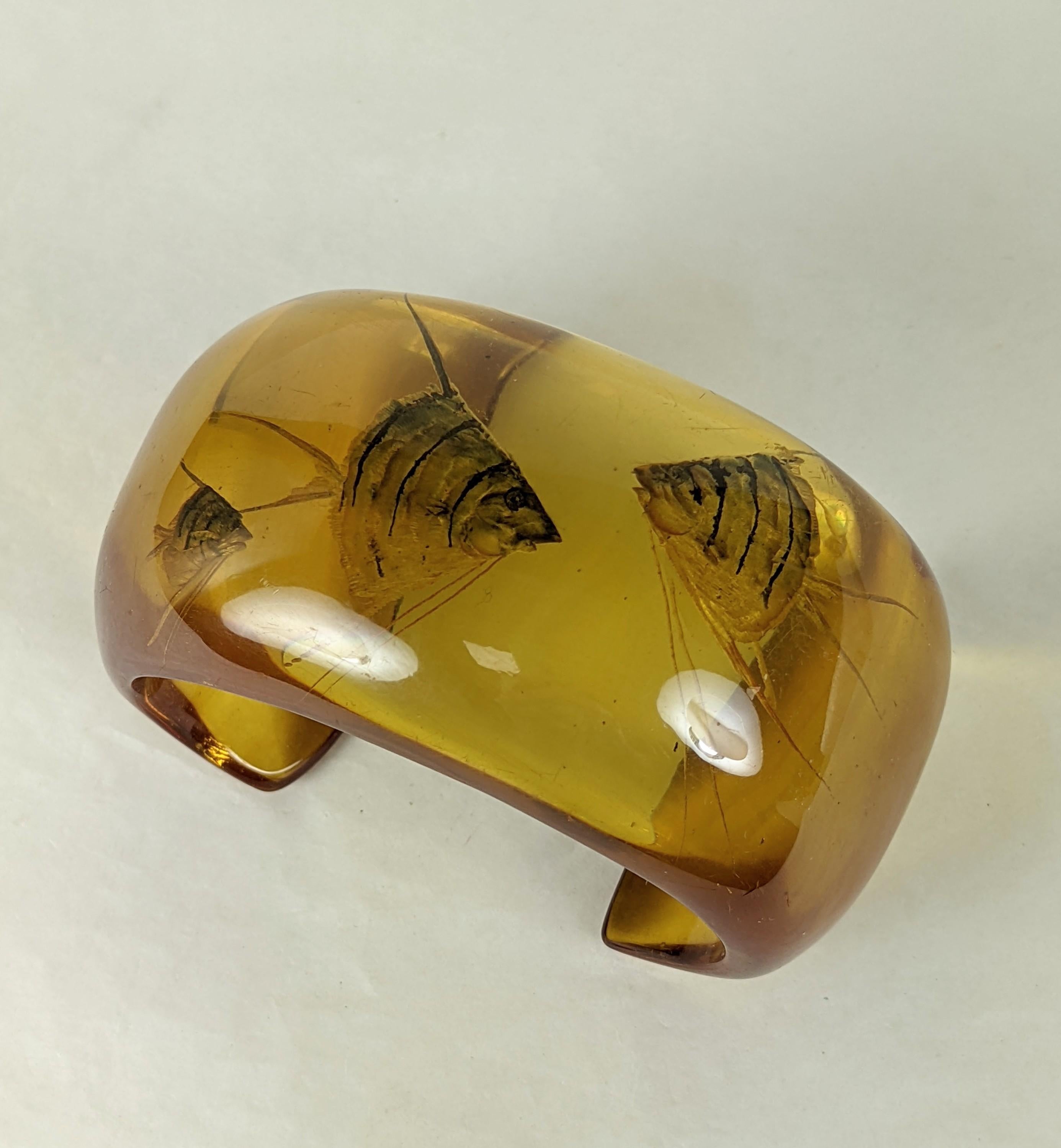 Exceptional and Rare Art Deco Reverse Carved Apple Juice Aquarium Bakelite Cuff from the 1930's. Reverse carved with 3 finely detailed angelfish which are then realistically overpainted in mother of pearl iridescent tones.  1 5/8
