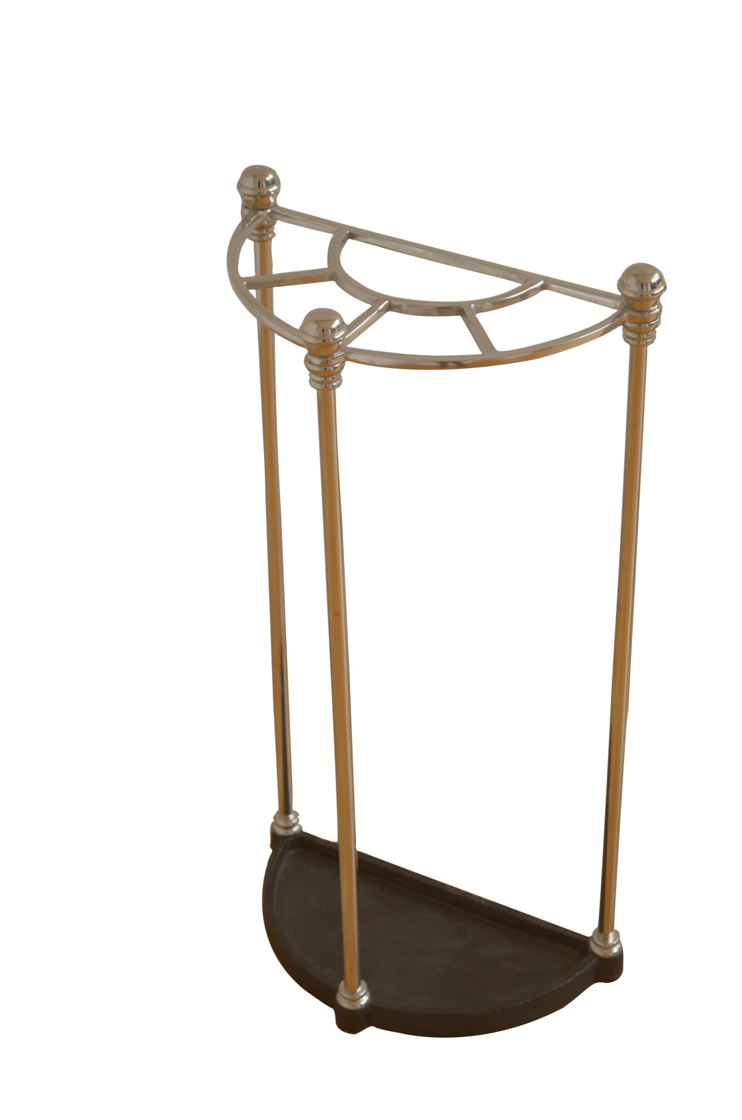 P0229  Very unusual Art Deco demi lune umbrella stand of narrow proportions with five divisions, decorative finials and a drip tray. This antique stand was cleaned and polished and is in home ready condition.  Just to avoid any confusion this