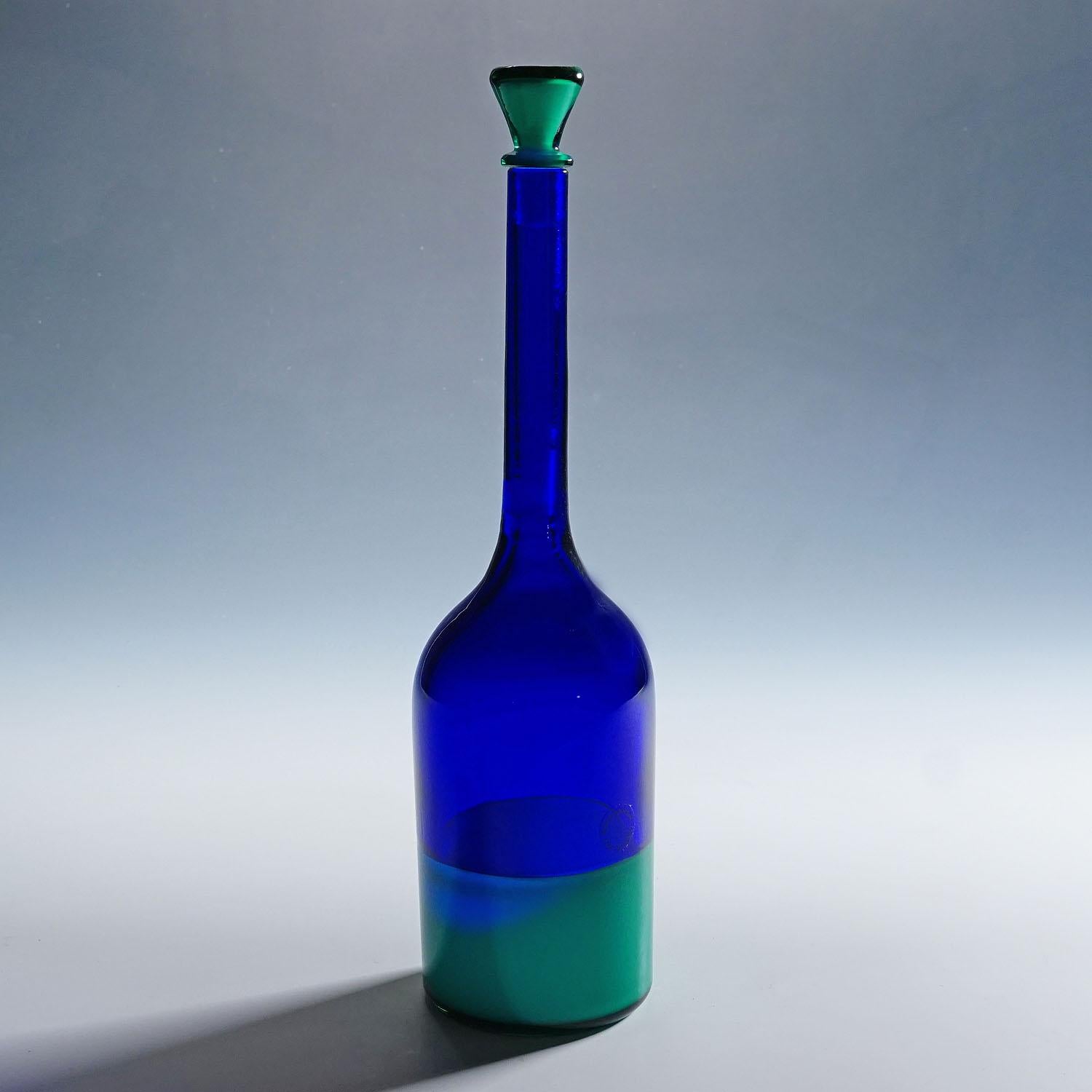 Rare Art Glass Bottle Morandiana by Gio Ponti for Venini Murano

A vintage art glass bottle in transparent blue glass with green stopper and a green base fused in incalmo technique. Designed by Gio Ponti in 1949 and manufactured by Venini Murano