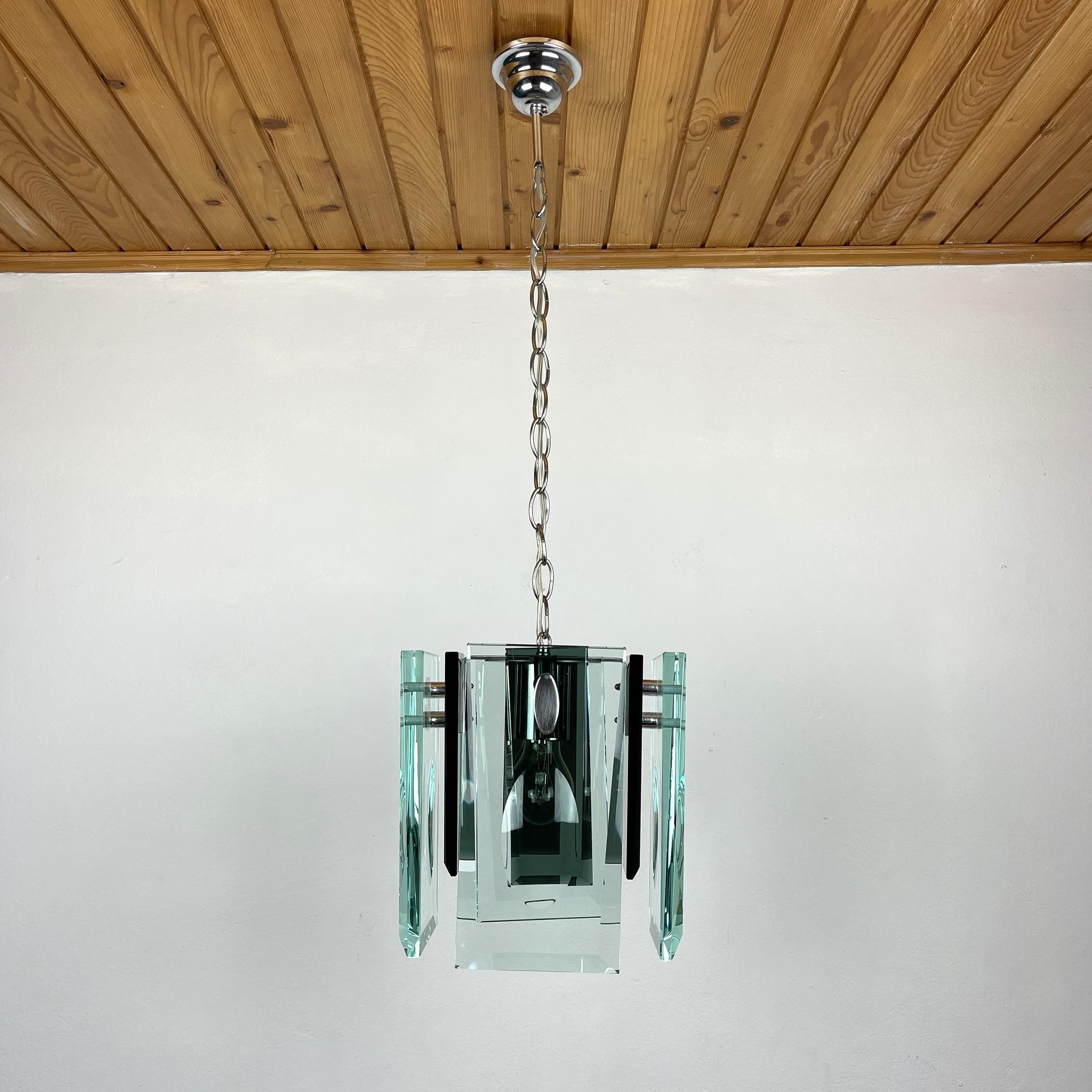 The rare Art glass chandelier by Fontana Arte made in Italy in the 70s. The unusual shape, beautiful thick green art glass creates a beautiful and effective light. Beautiful pale glass pieces have been shaped and highly polished with beveled ends to