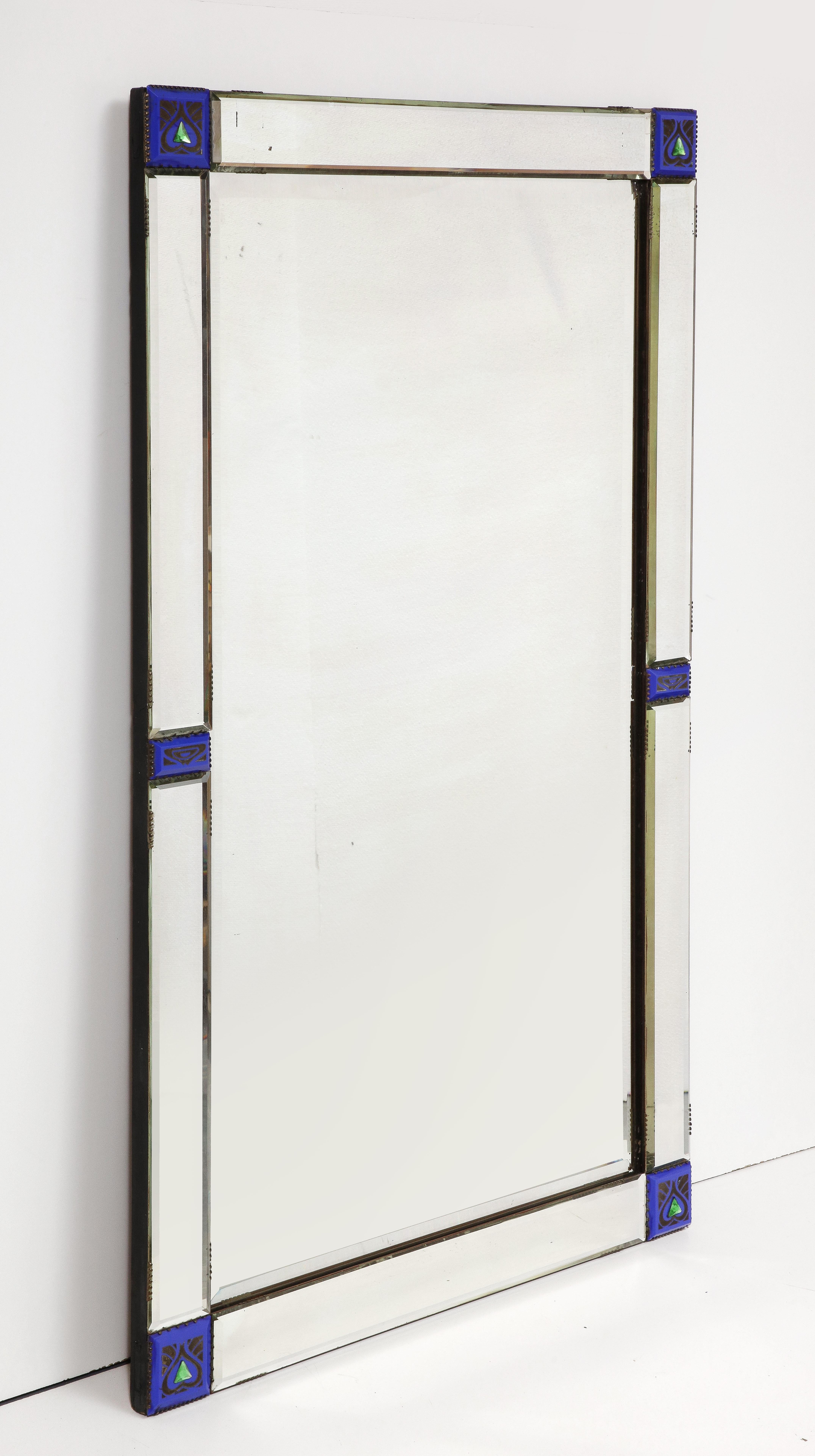 Rare Art Nouveau mirror, Italy, c. 1920. 

This special mirror consists of a beveled border with lozenge cut corners that are engraved with blue square sections, each emblazoned with an emerald green arrow.