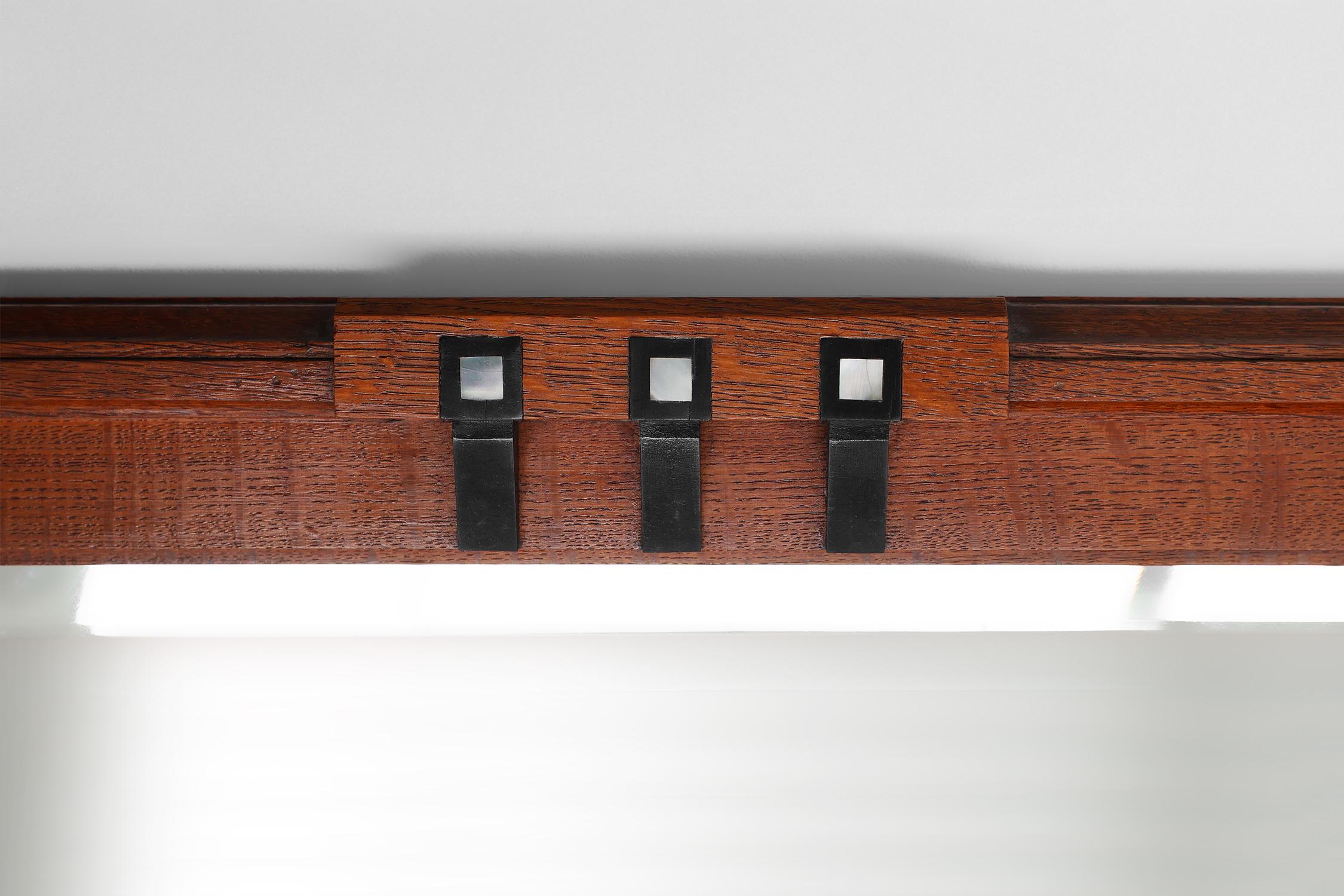 Belgium / 1905 / mantel mirror / De Coene / Oak / Art Deco / Art Nouveau

Large Art Nouveau mirror with facet cut mirror, subtle carvings and black and white inlay on the oak frame. This generous sized mirror was probably designed and crafted by the