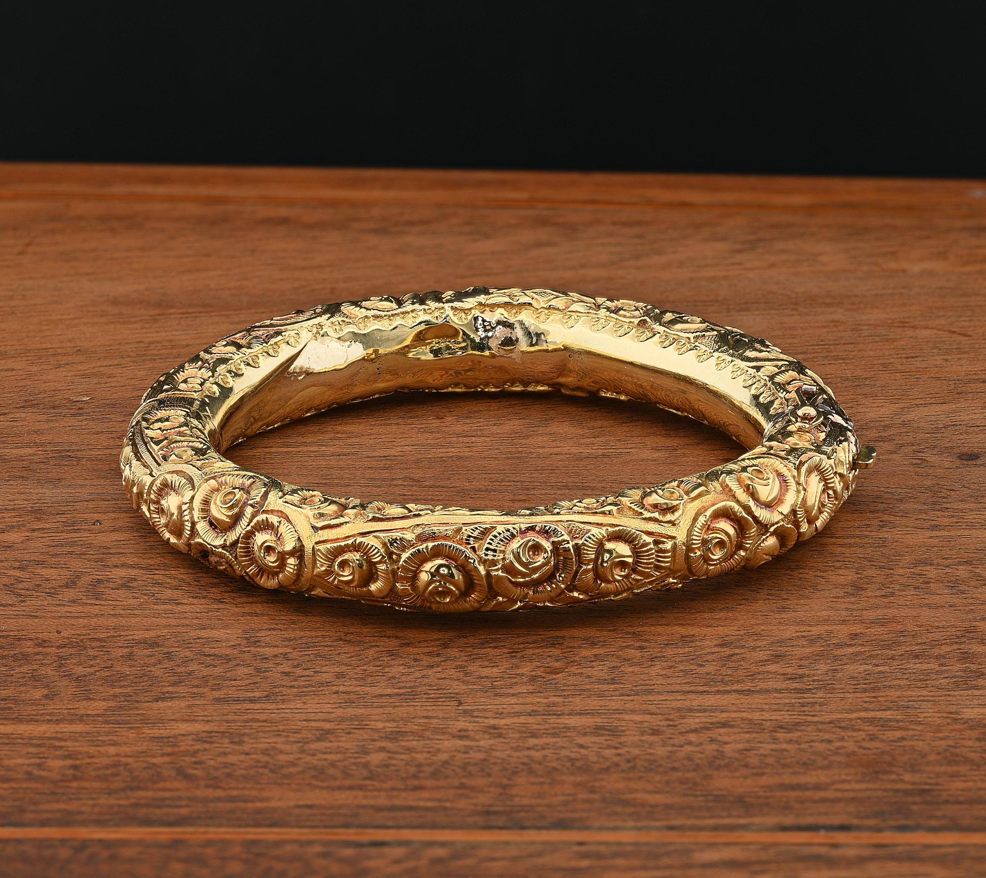 Rare authentic Art Nouveau period solid 18 Kt gold marked with extraordinary antique repousse hollow art work, nature inspired, richly detailed with rose buds and leaf work highly detailed taking life throughout the bangle
It is hinged with a side