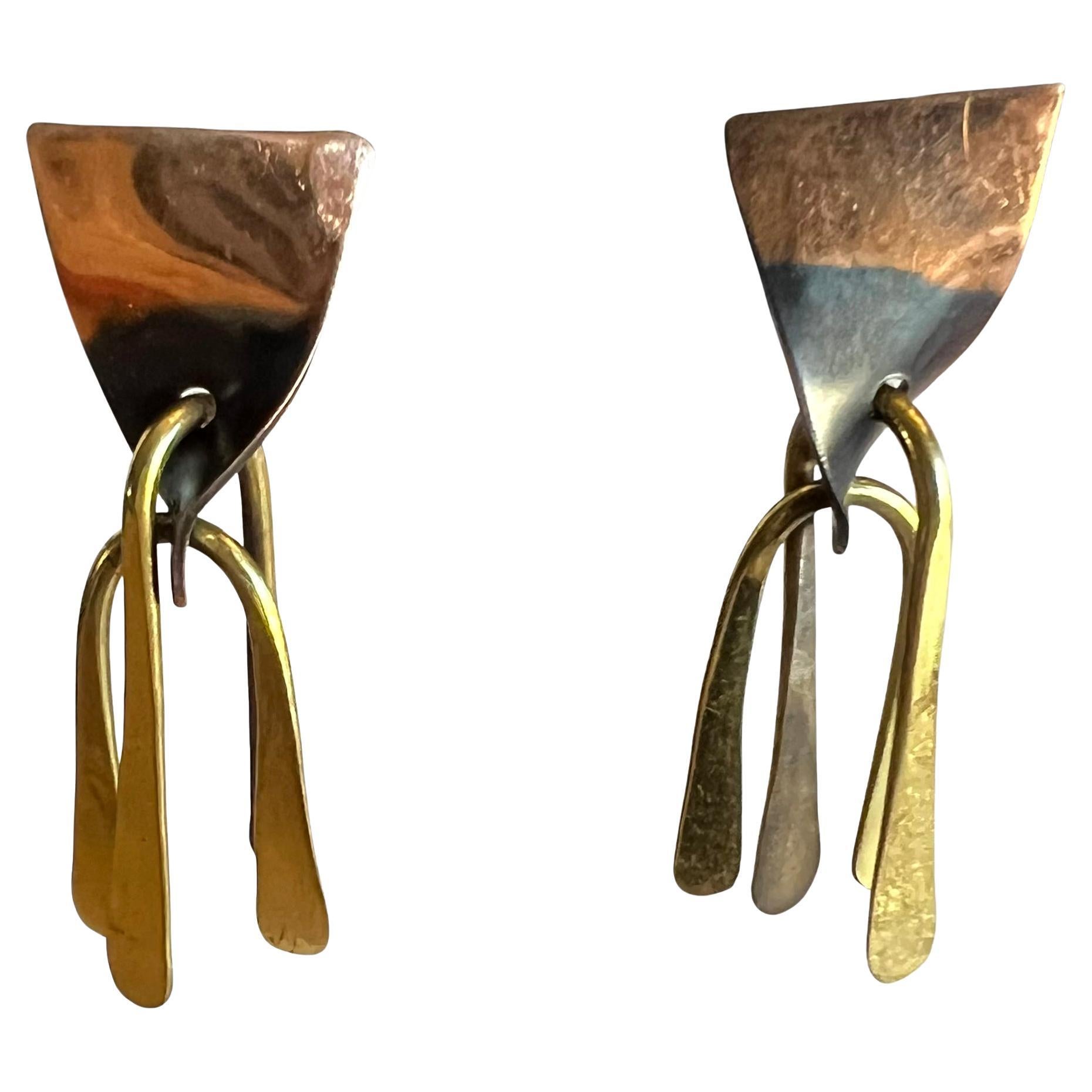 Rare, American modernist copper and brass kinetic earrings created by Arthur Smith, circa 1950s.  Screwback earrings create a soft chime when worn.  The measure 2