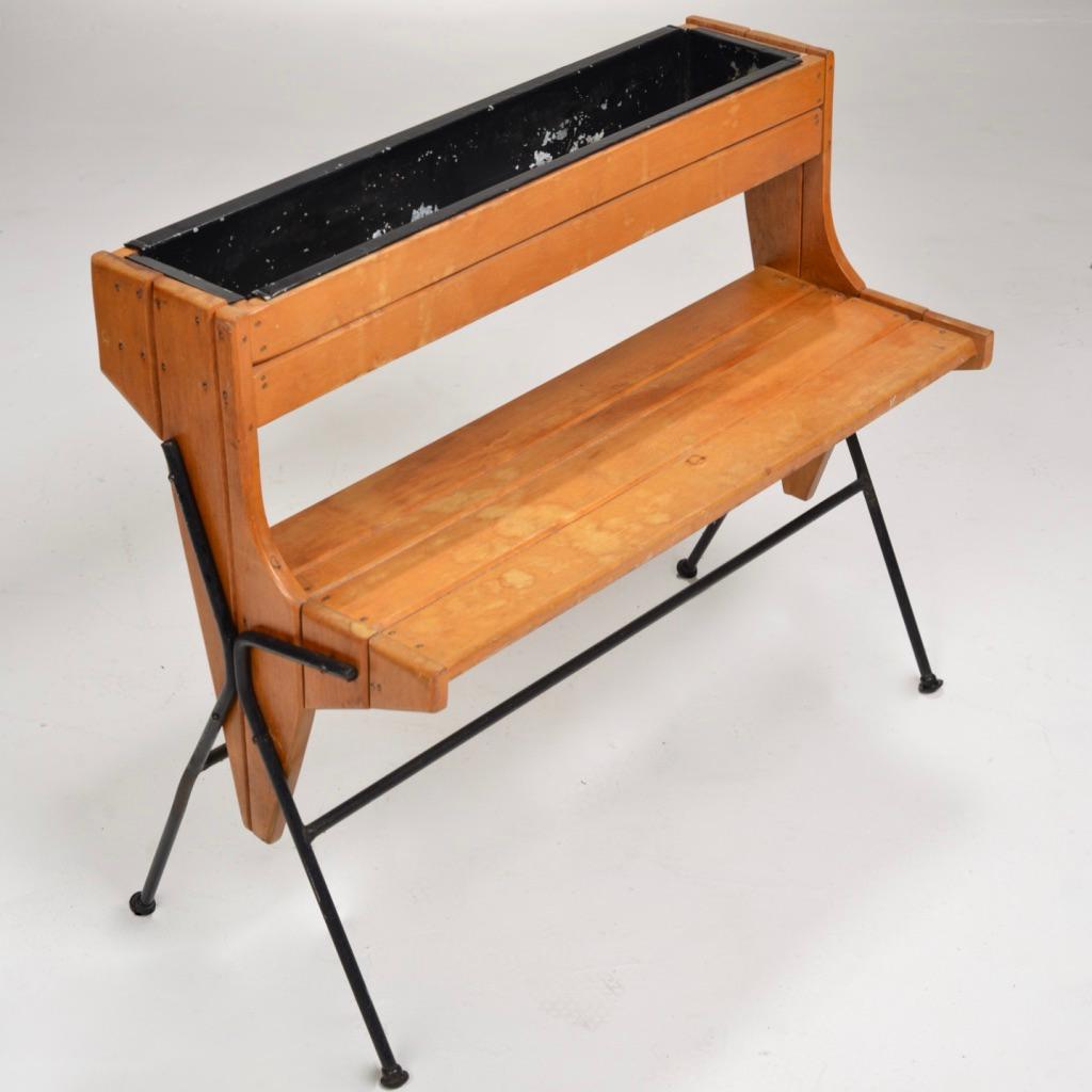 Rare 1950s Arthur Umanoff step-up planter stand. Wrought-iron and wood slats with a painted black aluminum insert.