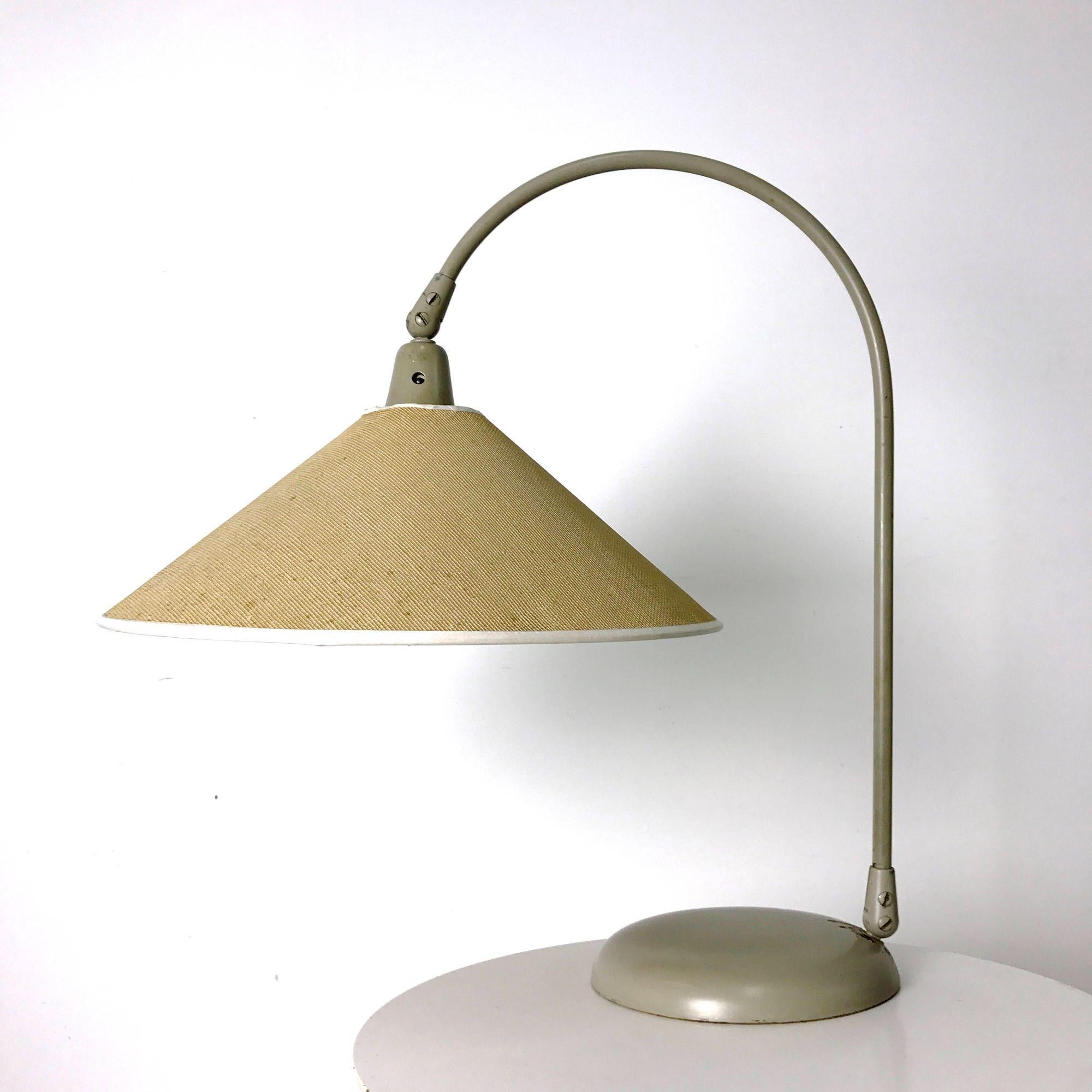 Rare Kurt Versen Articulated Table Lamp 1950's

Rare table lamp, model 4420, designed by Kurt Versen for Kurt Versen Lamps, Inc. early 1950's. Articulated shade and arced arm on enameled metal base, shade is original with new taping.
Signed with