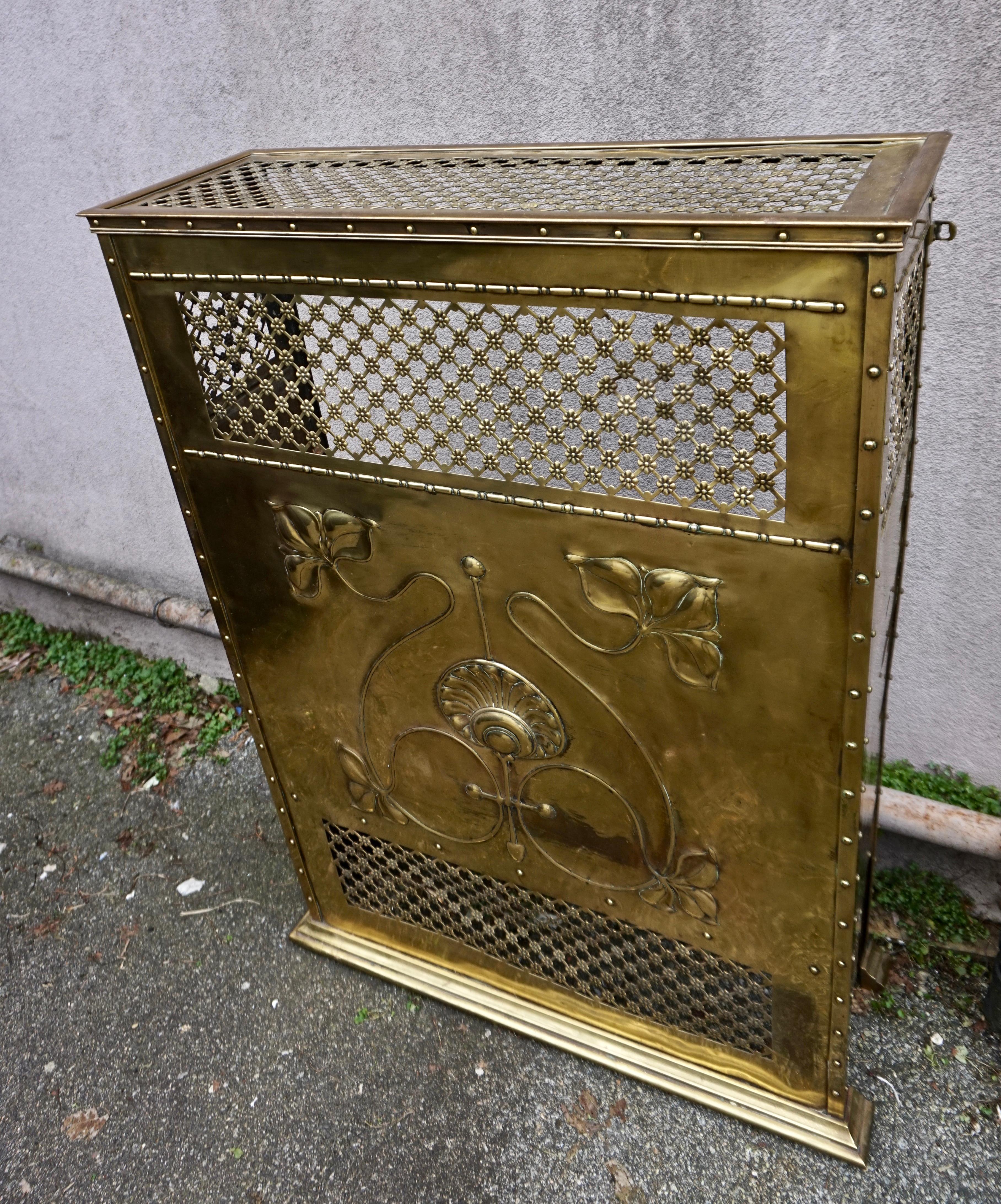 Rare all brass Arts & Crafts fireplace mantel screen from England with scrolling leaves and shell medallion motif. Highly creative statement mantel that can be used as intended or as a fireplace screen or objet d'art. Truly novel and exuding warmth.