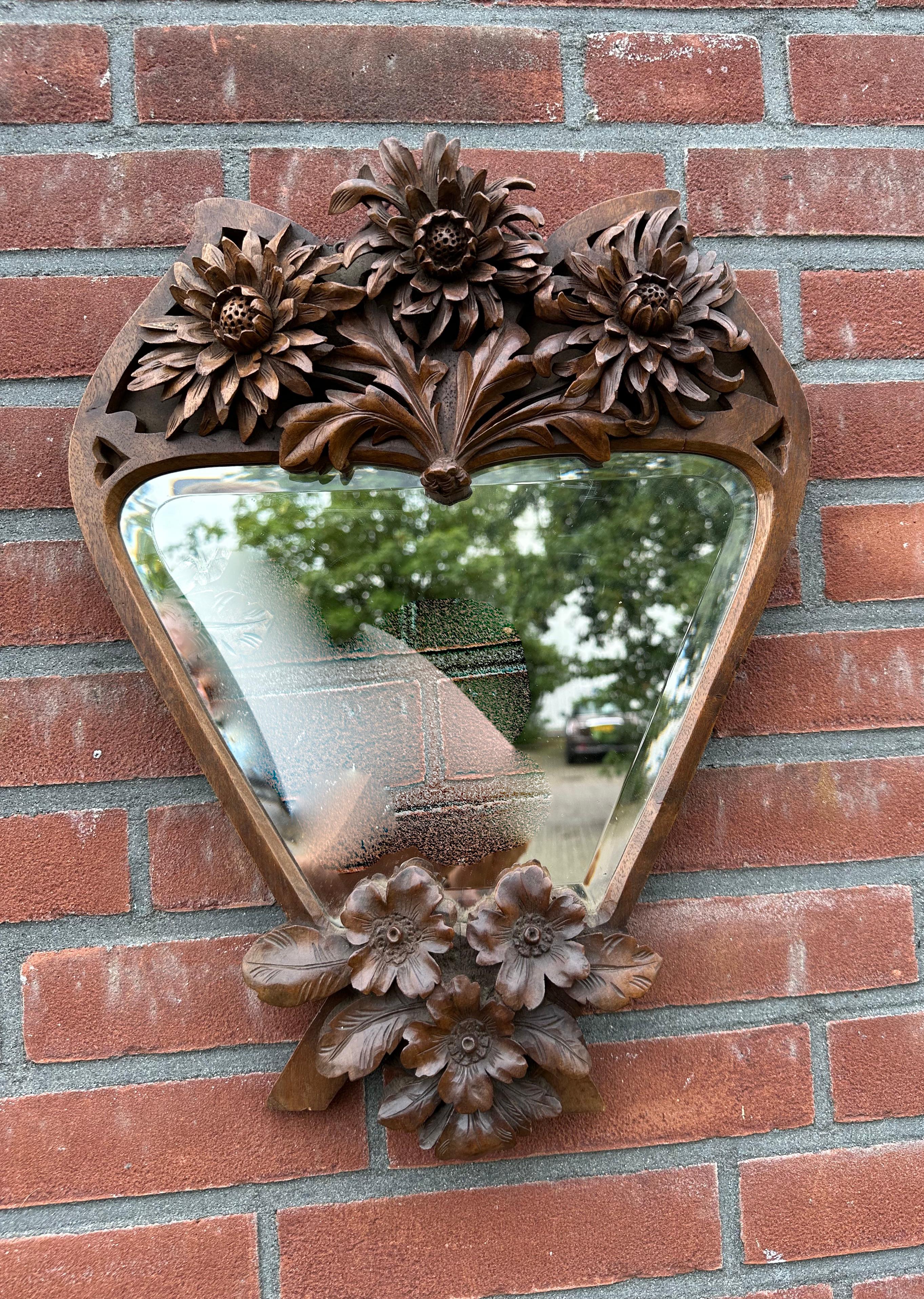 Beautifully hand carved and truly artistic antique mirror with beveled glass.

If you are looking for unique, top quality Arts & Crafts antiques to grace your living space then this one of a kind mirror could be flying your way soon. This is the