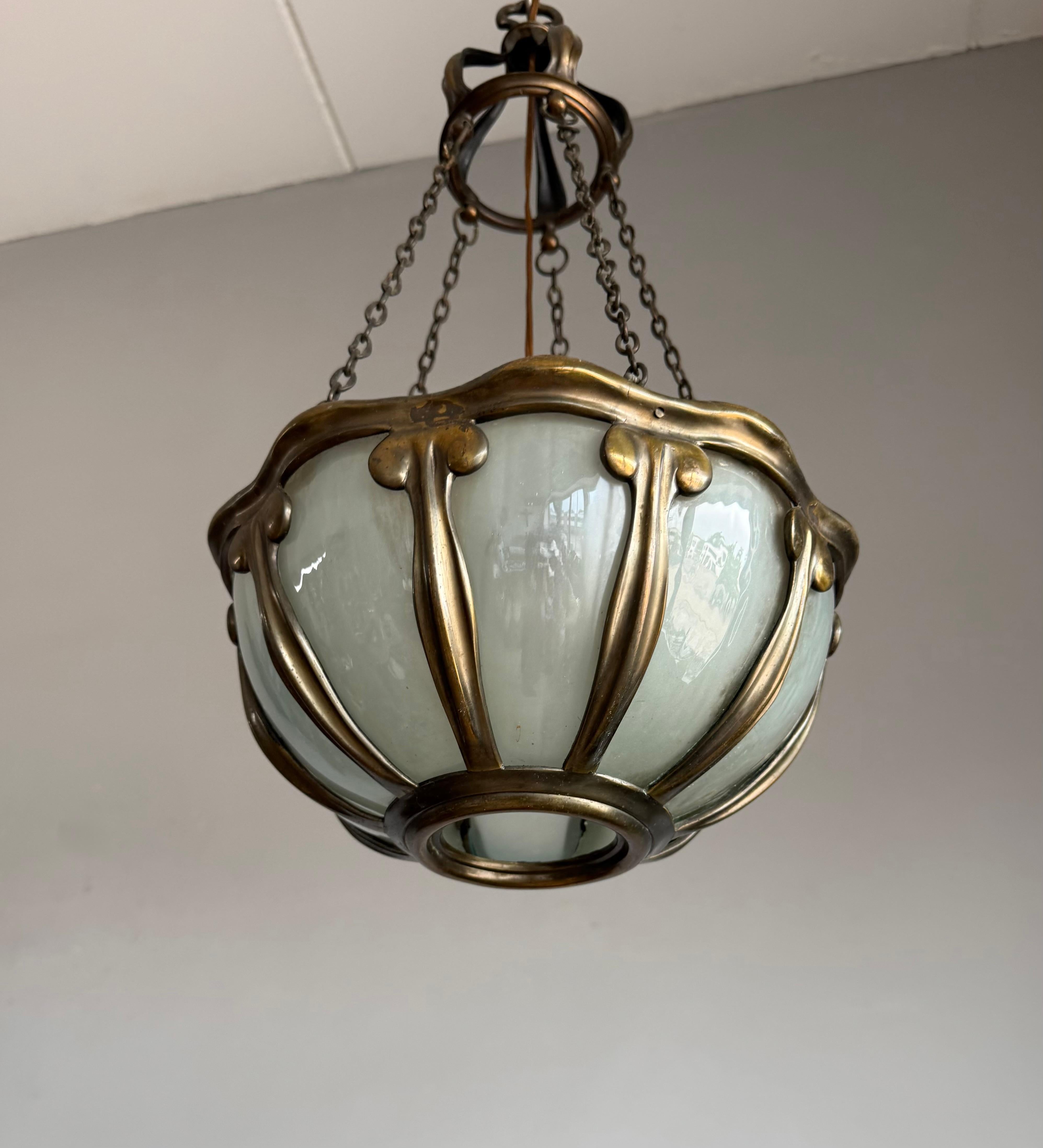 Antique Art Nouveau ceiling fixture with 10 hand-blown glass panels.

An exquisite and rare Art Nouveau pendant light, fully embodying the organic elegance and craftsmanship of the Jugendstil movement. This exceptional fixture is not just lighting