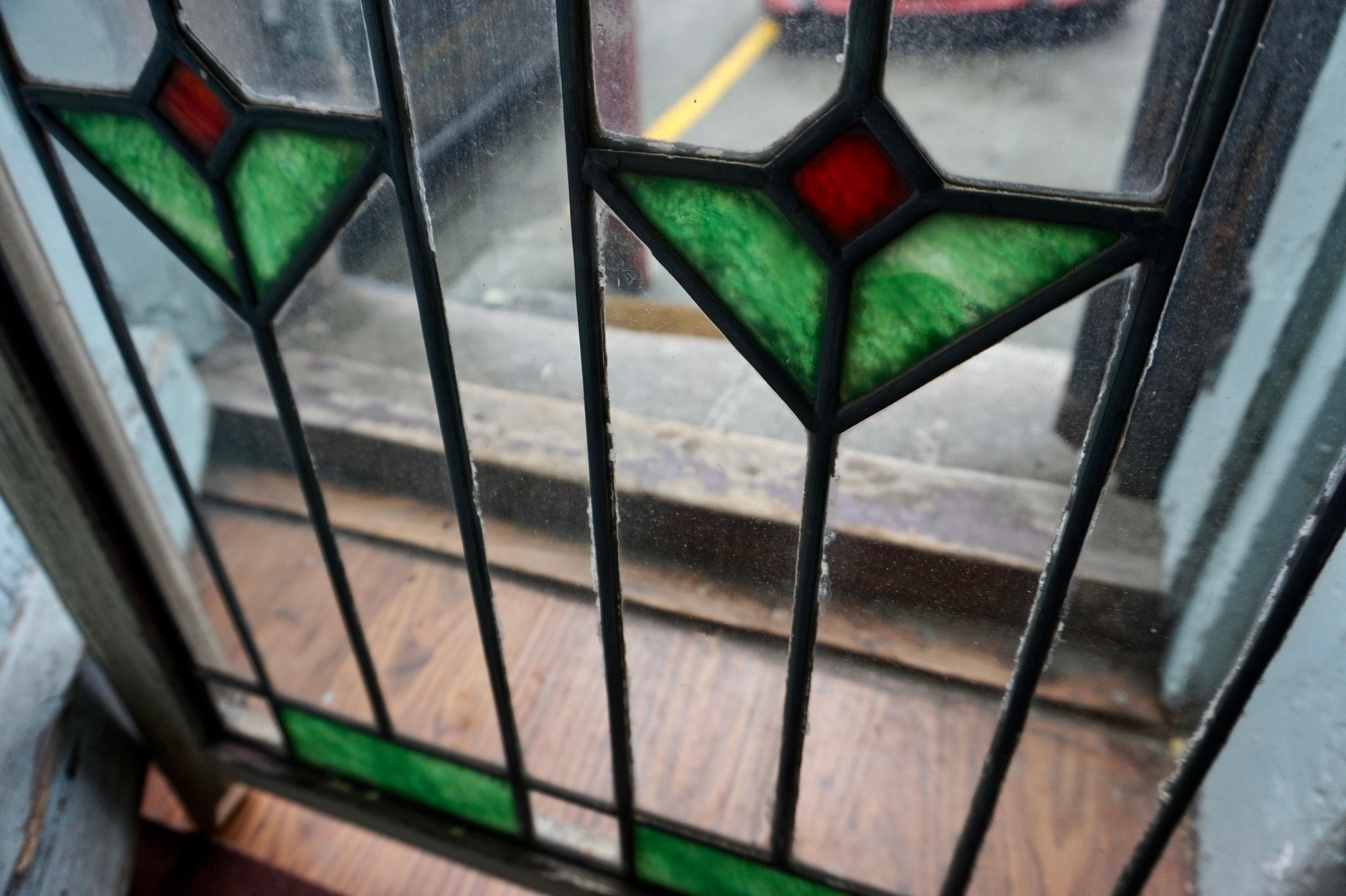 True Arts & Crafts two-tone geometric pair of stained glass windows. Subtle workmanship which exudes simplified elegance. In very good original condition. Wonderful to incorporate in that space which needs a touch of character or warmth. These are