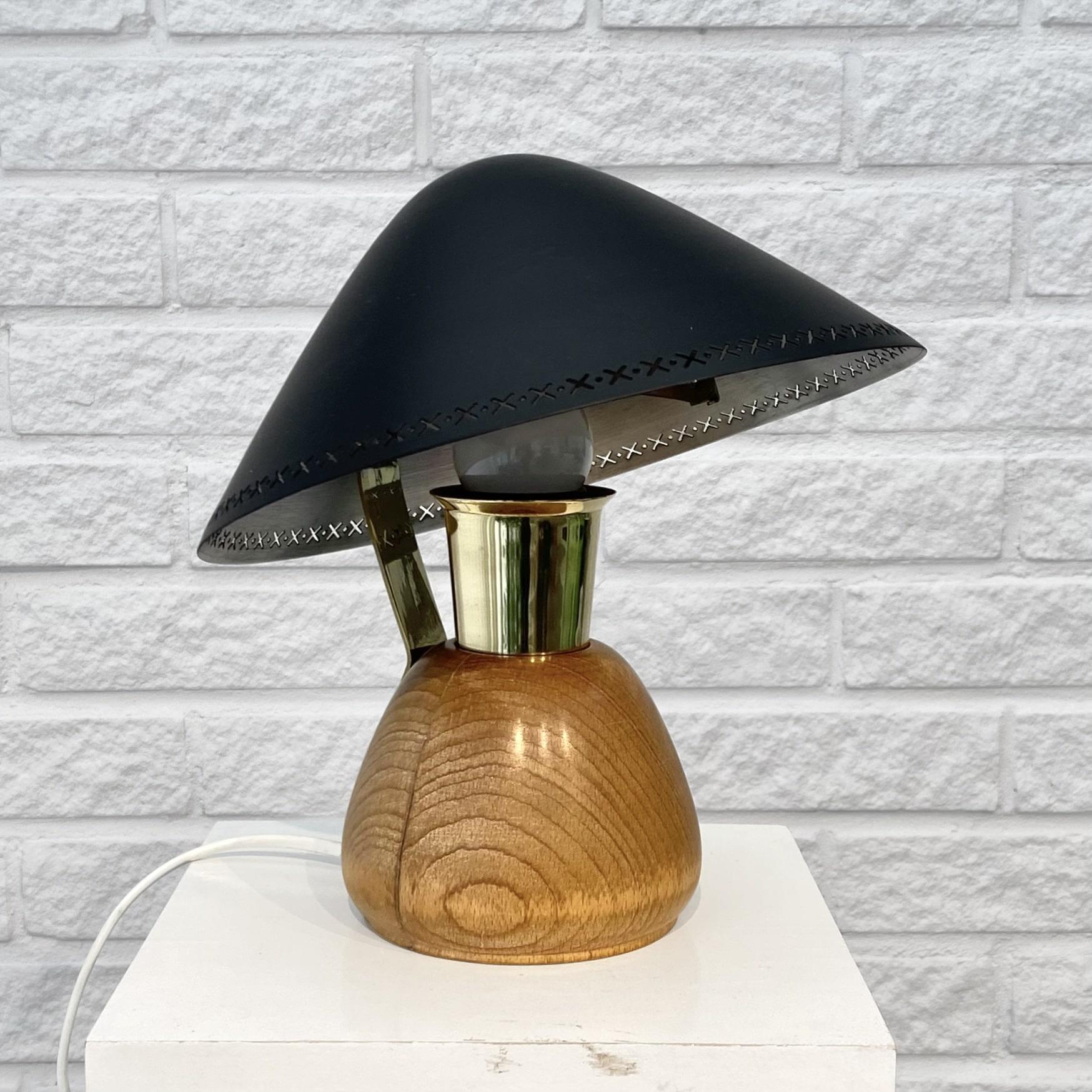 Rare ASEA table lamp, model E1272, dating back to the 1950s, featuring a rounded base crafted from solid wood. The disc shaped metal shade is adjustable and held just place by a brass arm.

ASEA, the Swedish electrical company, was established as