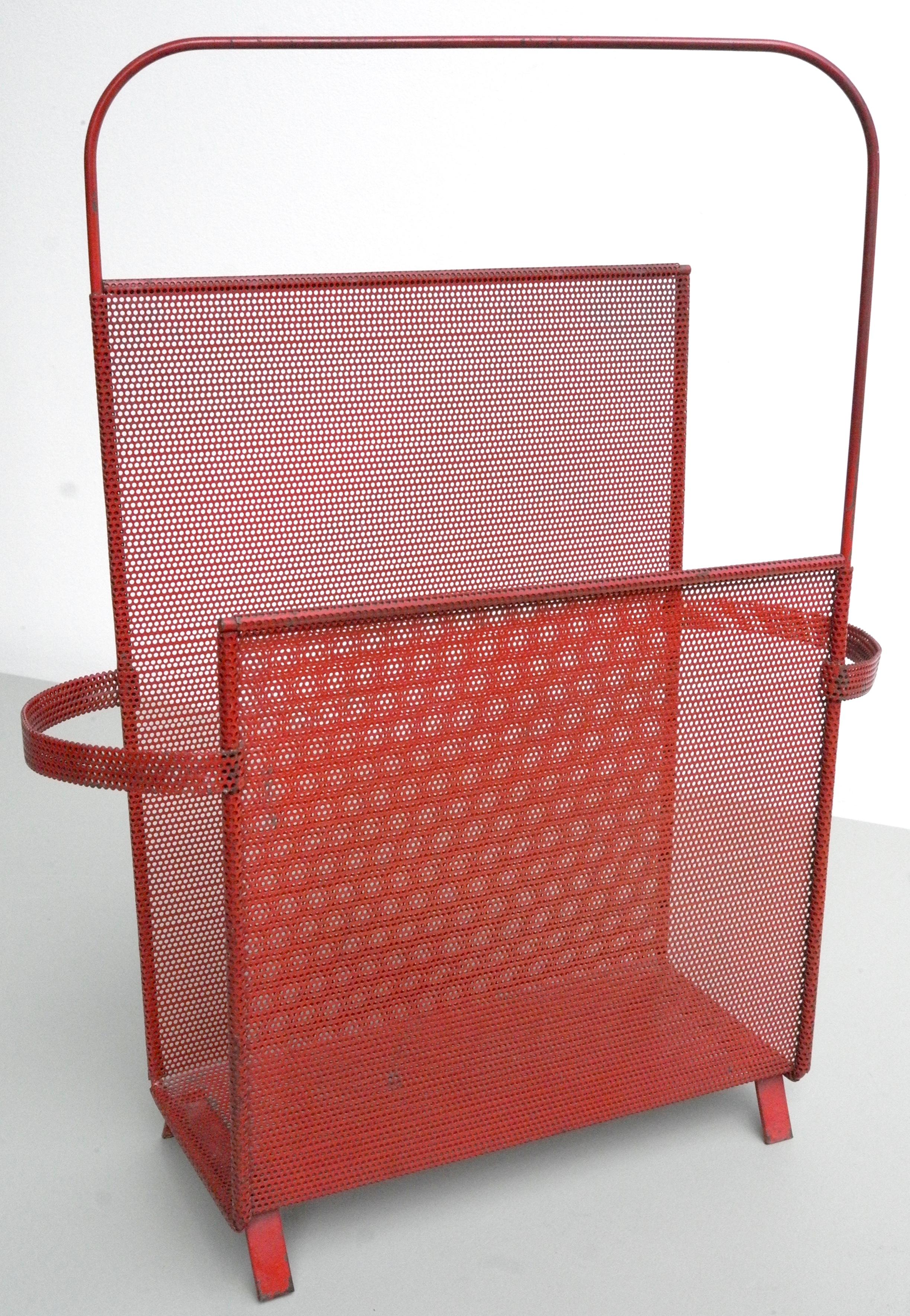 Magazine holder designed by Mathieu Matégot, rare Asymmetrical model in red metal. Manufactured by Ateliers Matégot, circa 1950. Folded, perforated metal.