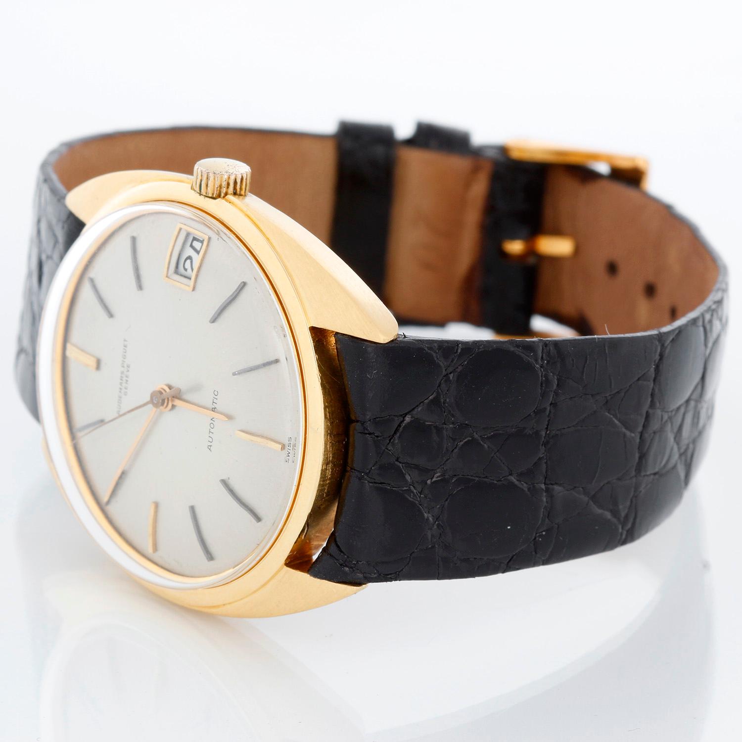 Rare Audemars Piguet 18K Yellow Gold Ref 5205BA Men's Watch - Automatic. 18K Yellow gold ( 35 mm ). Silver sunburst dial with cardinal indexes; date at 3 o'clock. Black Audemars Piguet leather strap band with tang buckle. Pre-owned with custom box.