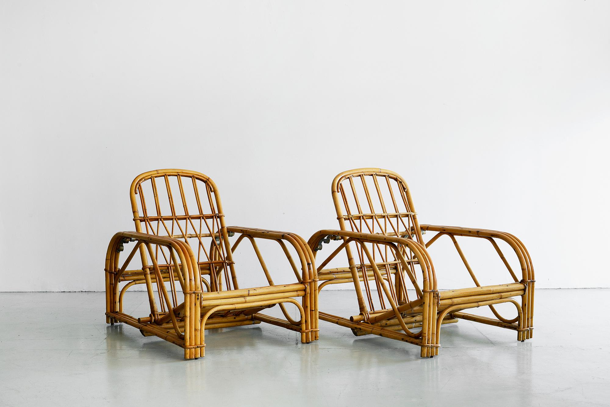 Rare pair of signed Audoux Minet rattan lounge chairs with ability to recline.
Original piece of bamboo lays between 3 brass rings that chooses your recline. 
Signature of brand on chairs. 
Cushions manufactured to customer's specification.
