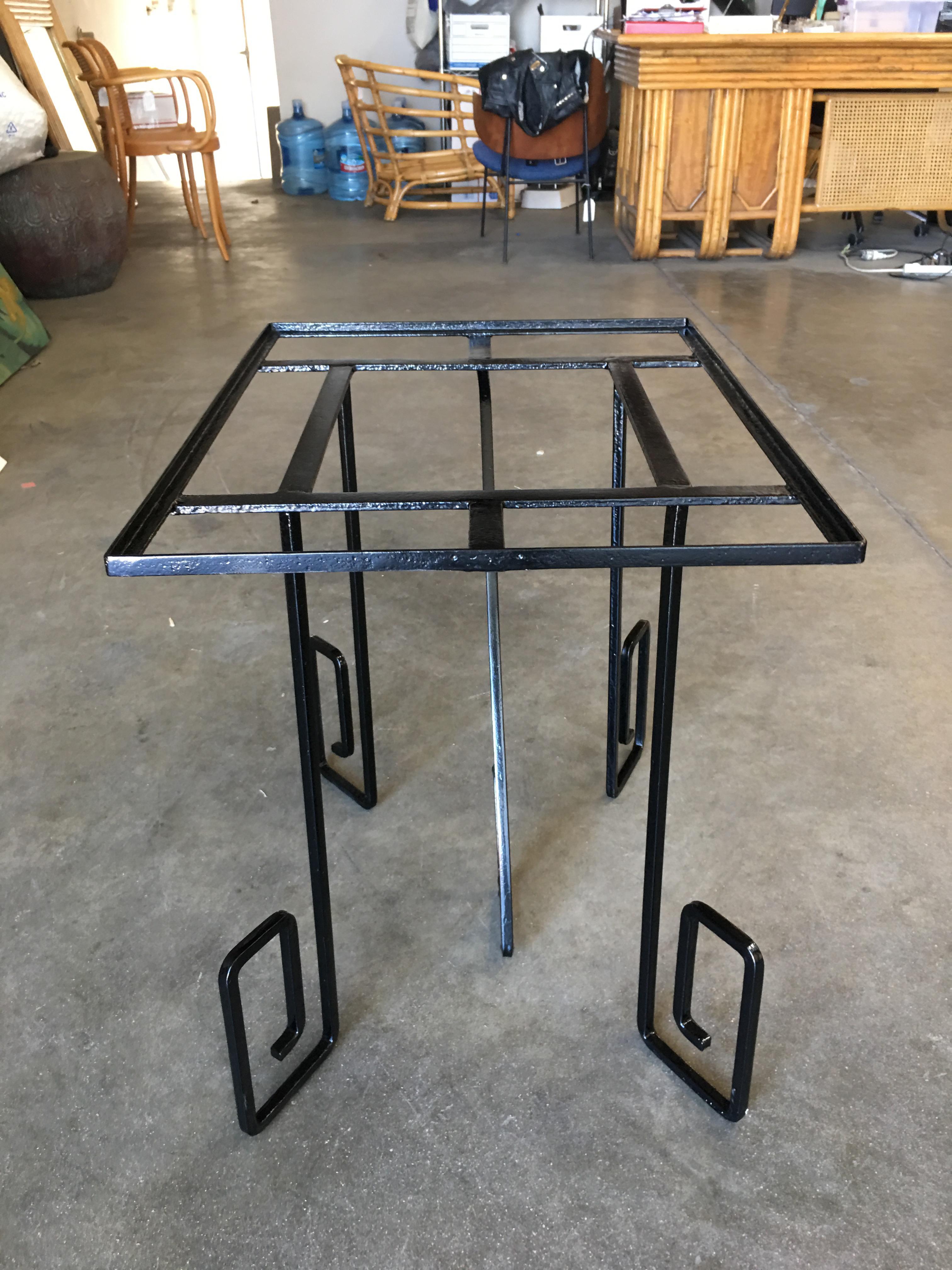 Rare Art Deco era Avant-garde scrolling Iron dining Table featuring oversized asymmetric scrolling legs reminiscent of German Expressionism films in the 1920s. The table features a rectangle-shaped top with 4 geometric-shaped scrolling legs and a