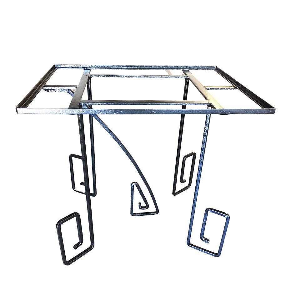 Rare Art Deco era Avant-garde scrolling Iron dining Table featuring oversized asymmetric scrolling legs reminiscent of German Expressionism films in the 1920s. The table features a rectangle-shaped top with 4 geometric-shaped scrolling legs and a