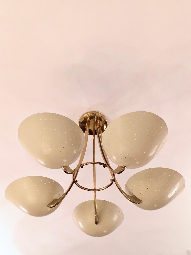 Rare and elegant brass and perforated aluminum 5 shades chandelier produced by BAG Turgi, Switzerland, circa 1950s
Very good vintage condition.
Measures: 42 cm high, 70 cm diameter.
   