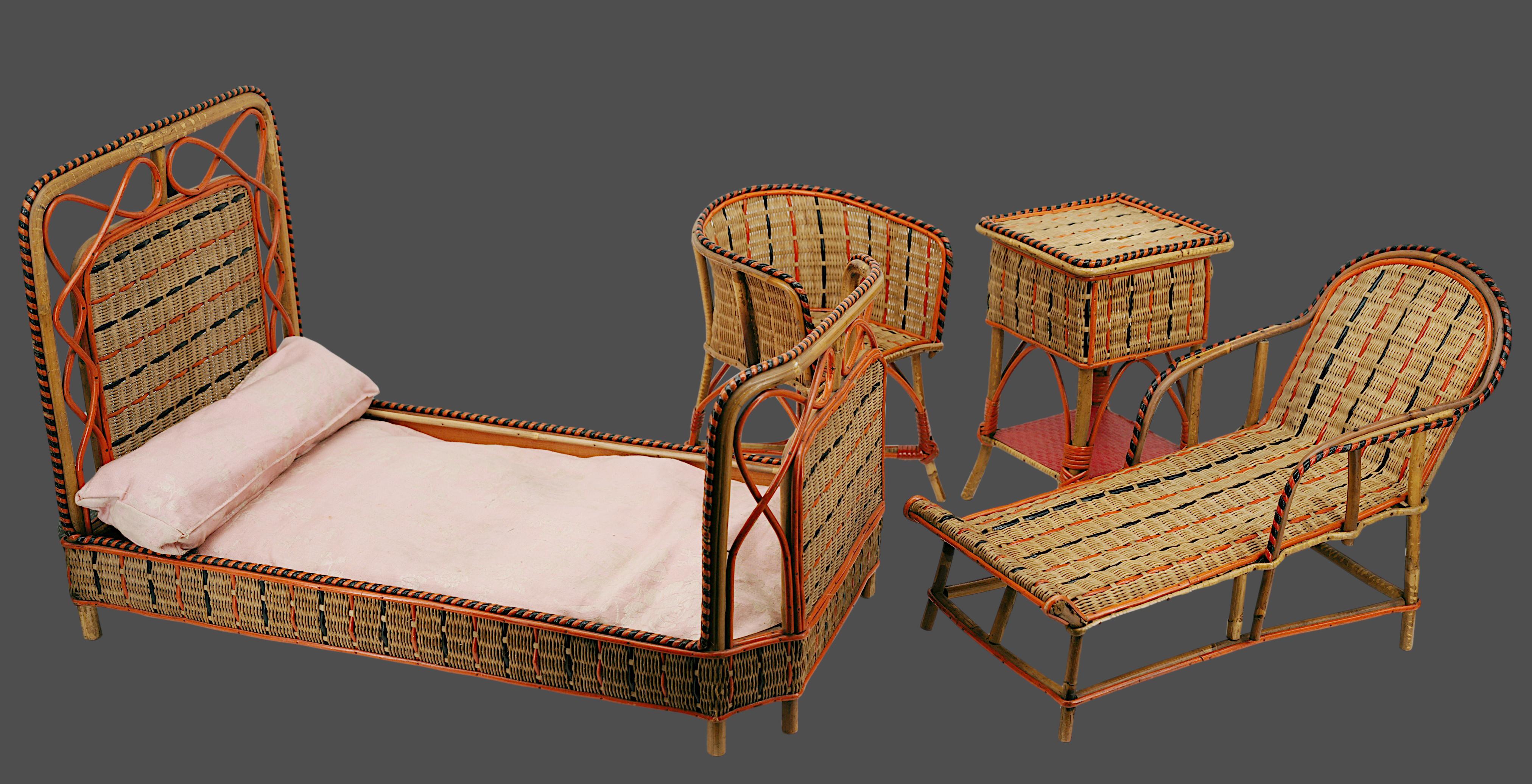 This charming and rare French doll's bedroom playhouse, dating from around 1900, is a delightful example of antique bamboo, rattan, and wicker craftsmanship. Featuring a set of miniature furniture that includes a bed, table, armchair, and chaise