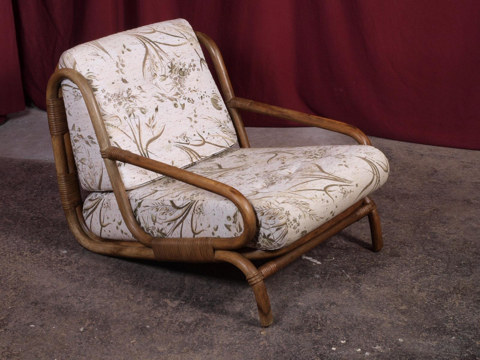 Excellent condition rattan lounge chair with rare well-preserved cane bindings, showcasing lovely curved legs and a smooth entry. Its inviting comfort tempts you to unwind for a drink or a sunlit nap. The enduring fabric and organic form promise