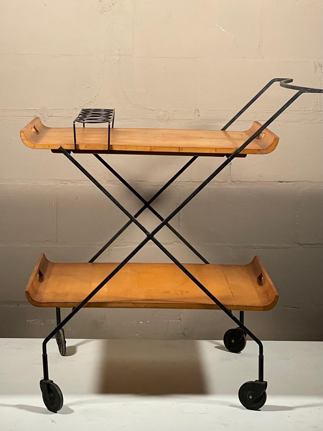 A rare and unusual bar cart designed by Milo Baughman for Murray Furniture and made ca' early 1950's. Wrought iron and solid maple, removable serving trays. Great example of American post war design, excellent original condition and patina.