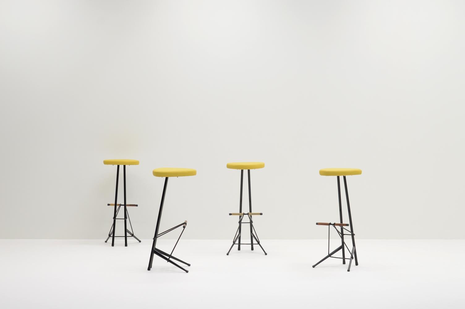 Rare bar stools by Willy van der Meeren for Tubax, Belgium 50s. The production was limited which makes these stools hard to find. The stools are refinished in the original black color, reupholstered with yellow skai leather and have the original